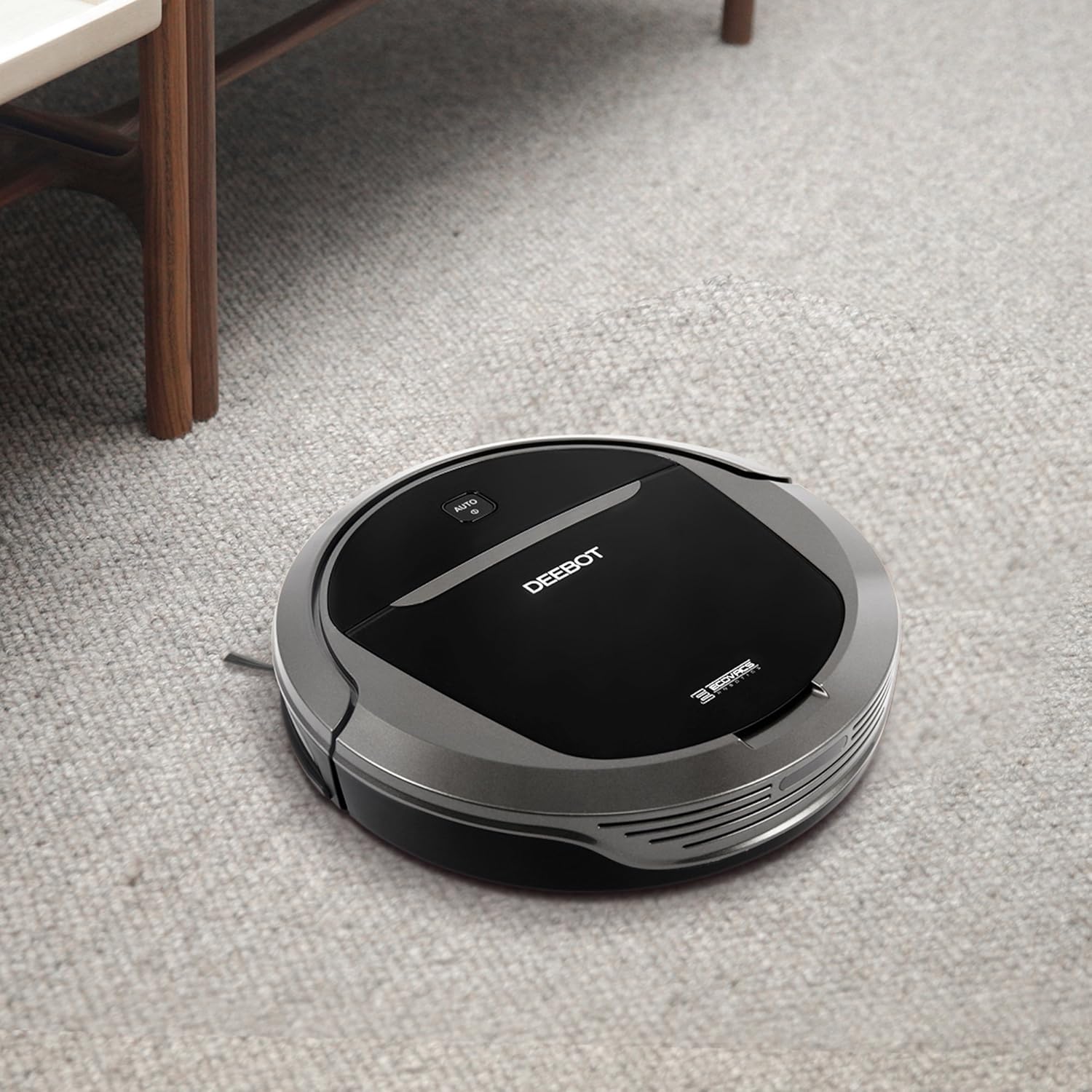 The ECOVACS DEEBOT M81PRO cleaning a low-pile carpet in a room, showcasing its multi-surface capability.