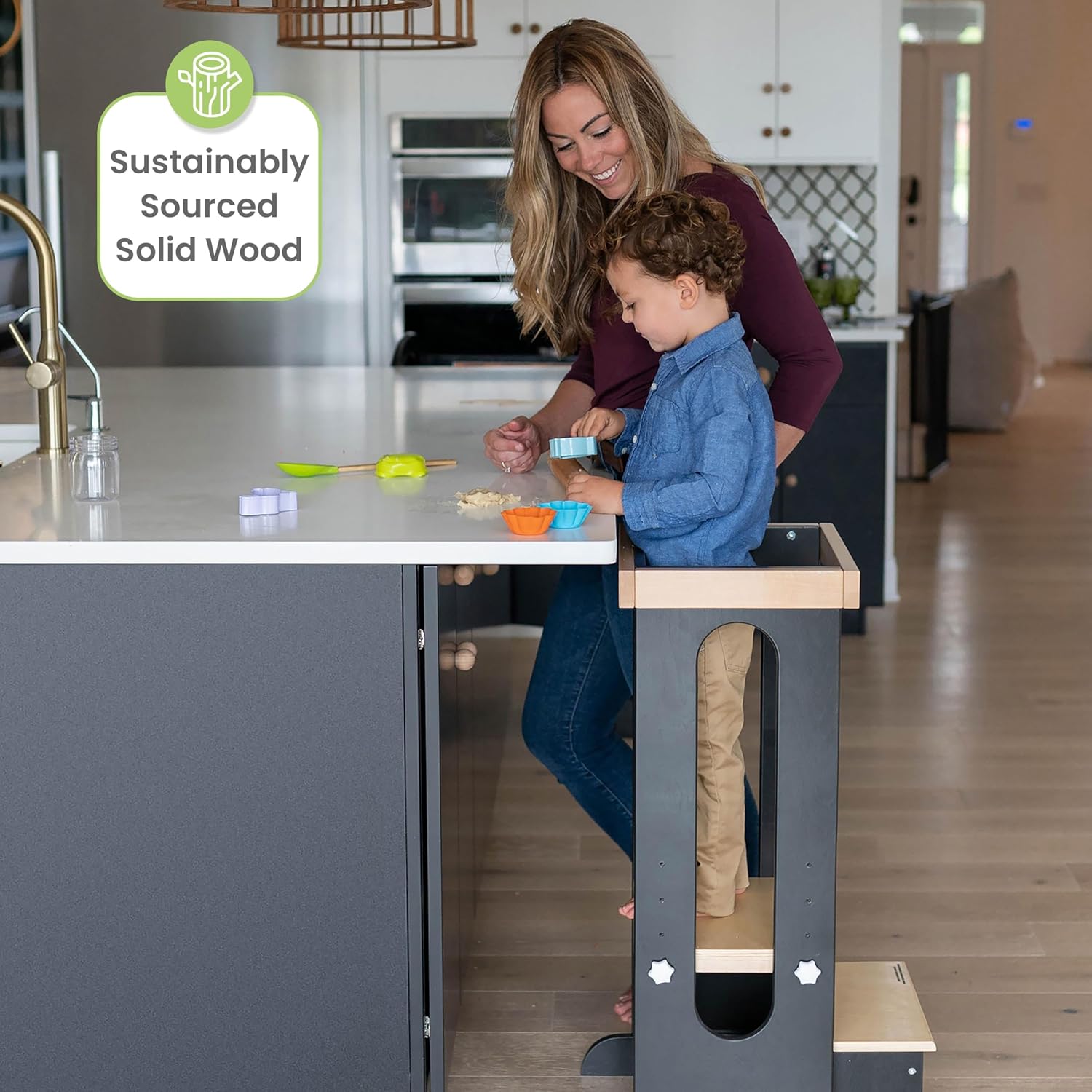 Child and adult baking together using the toddler tower