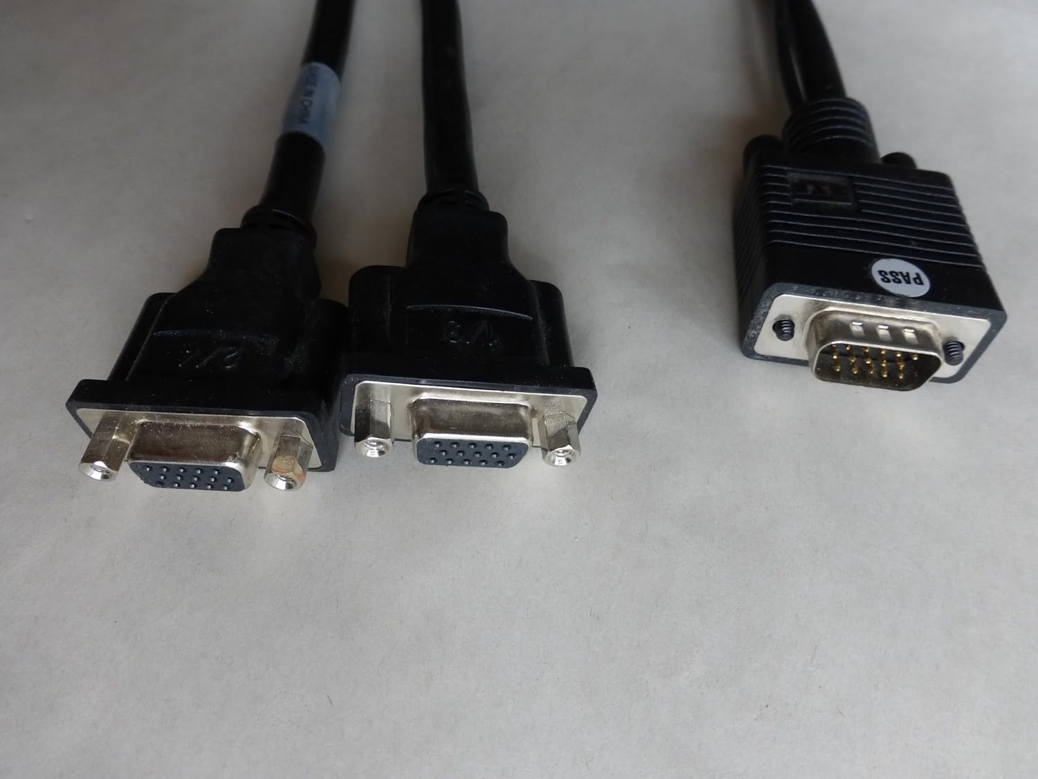Close-up of two VGA connectors and one DMS-59 connector on a Y-cable