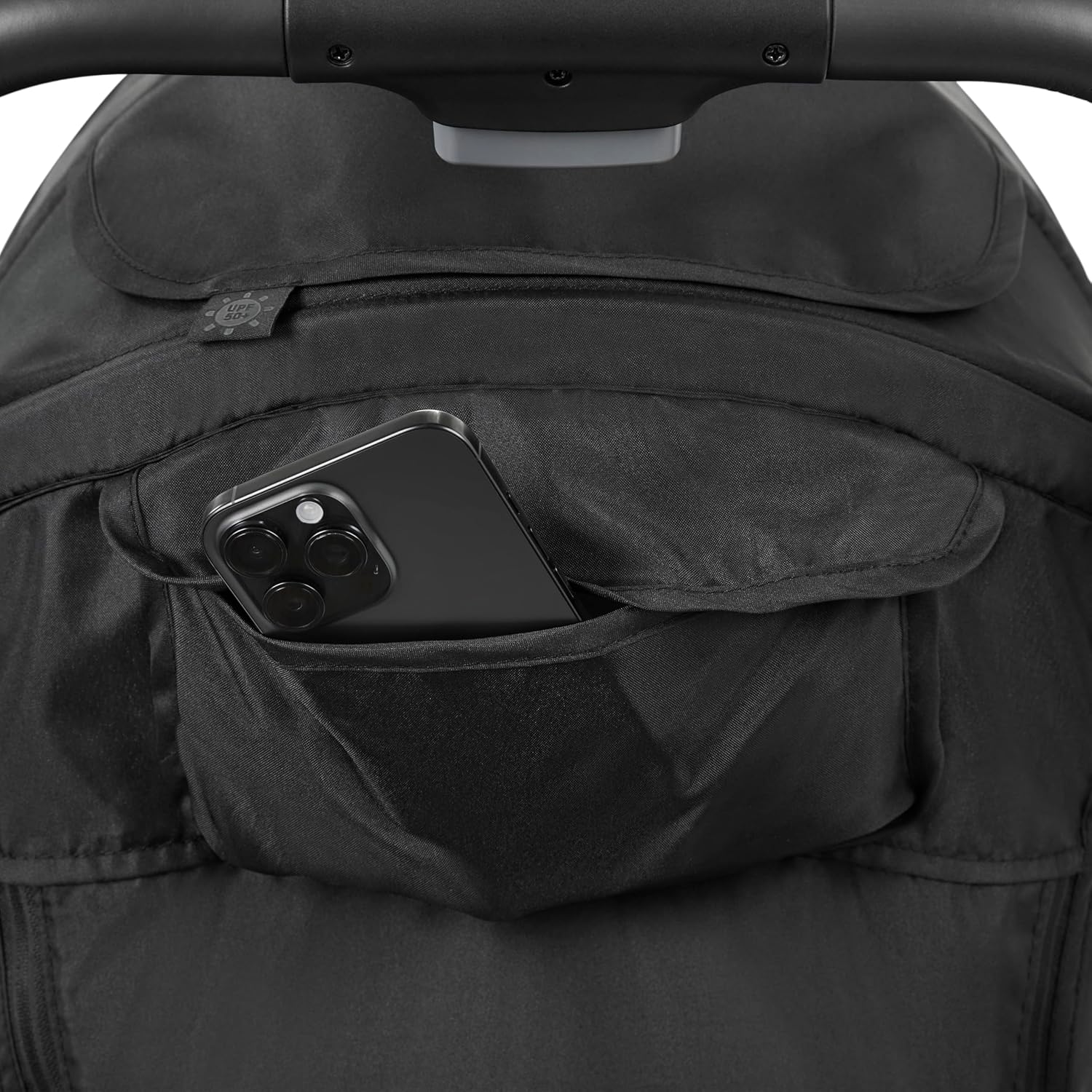 A smartphone placed in the accessory pocket on the canopy of the Ingenuity 3Dquickclose CS+ Stroller.