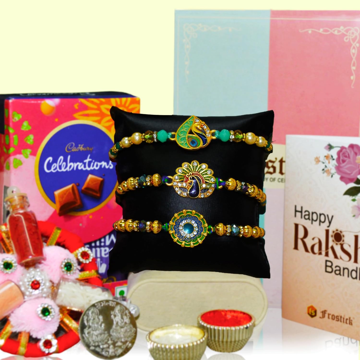 Frostick Rakhi Gift Combo for Brother – Pack of 3 Rakhis, Cadbury Celebrations 50 pack, Roli Chawal & Greeting Card | Raksha Bandhan Hamper for Men