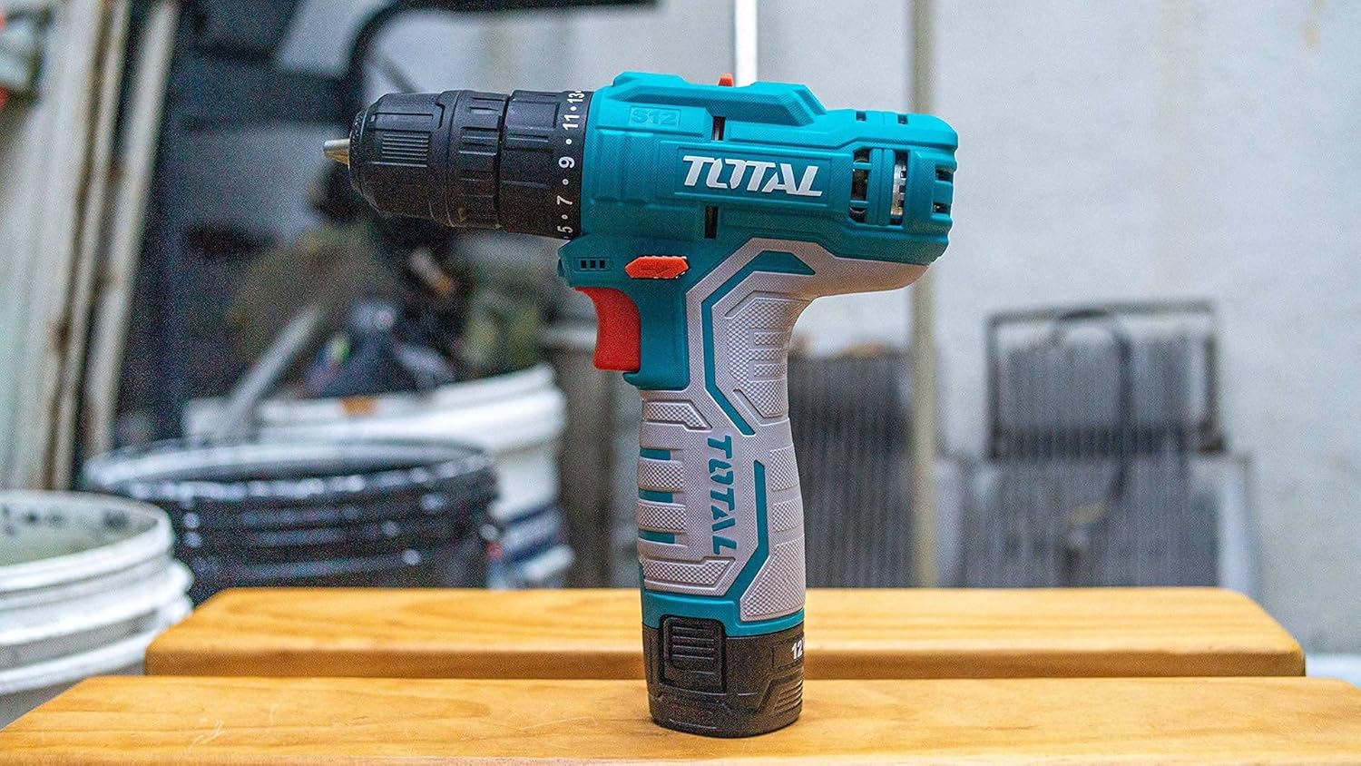 Lato view of the TOTAL TDLI12325 Cordless Drill on a wooden surface
