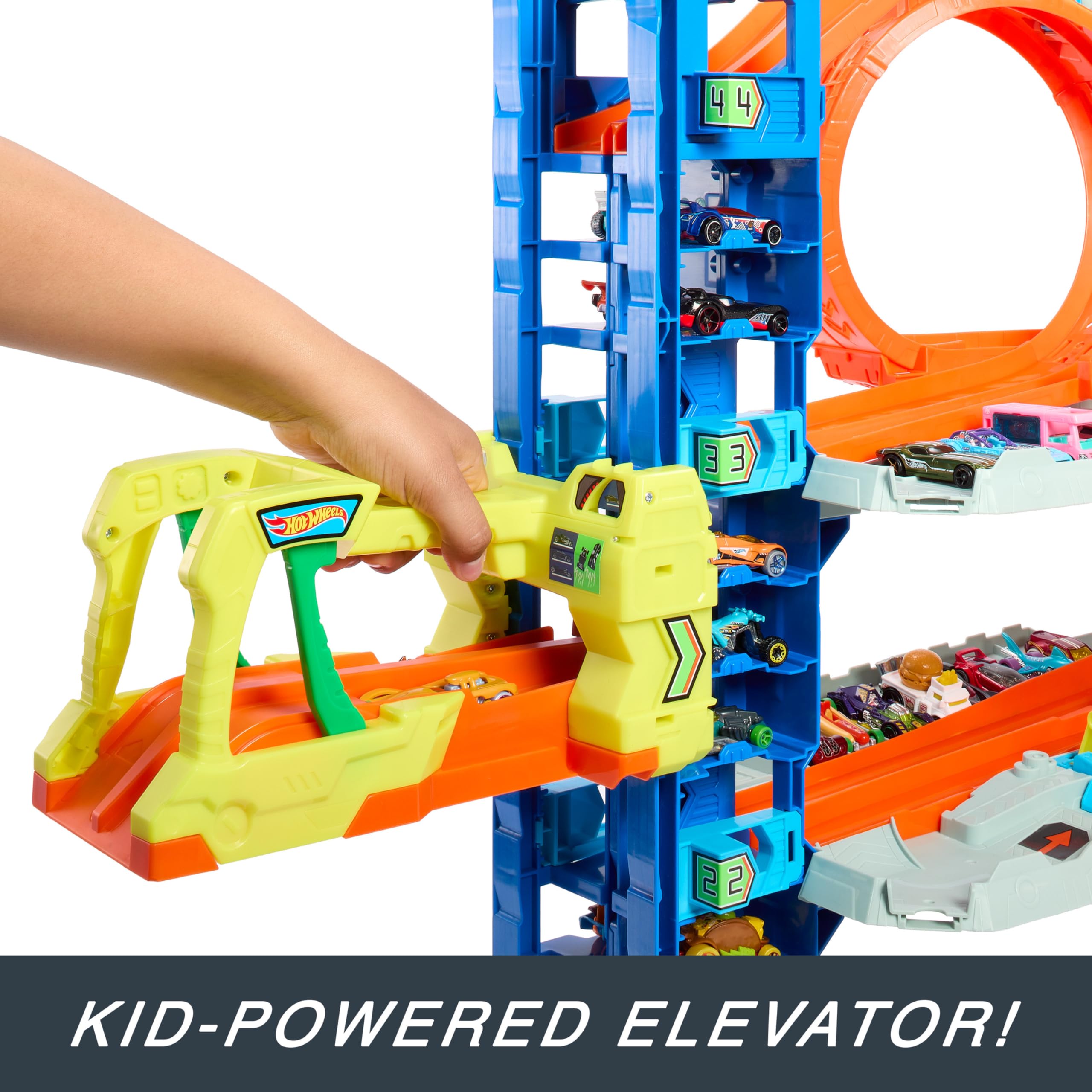 Hot Wheels City “Let's Race - ¡a Correr!” Netflix - Garaje definitivo Pista para Coches de Juguete con dragón y 4 Niveles, Incluye 2 vehículos, +4 años (Mattel HKX48)