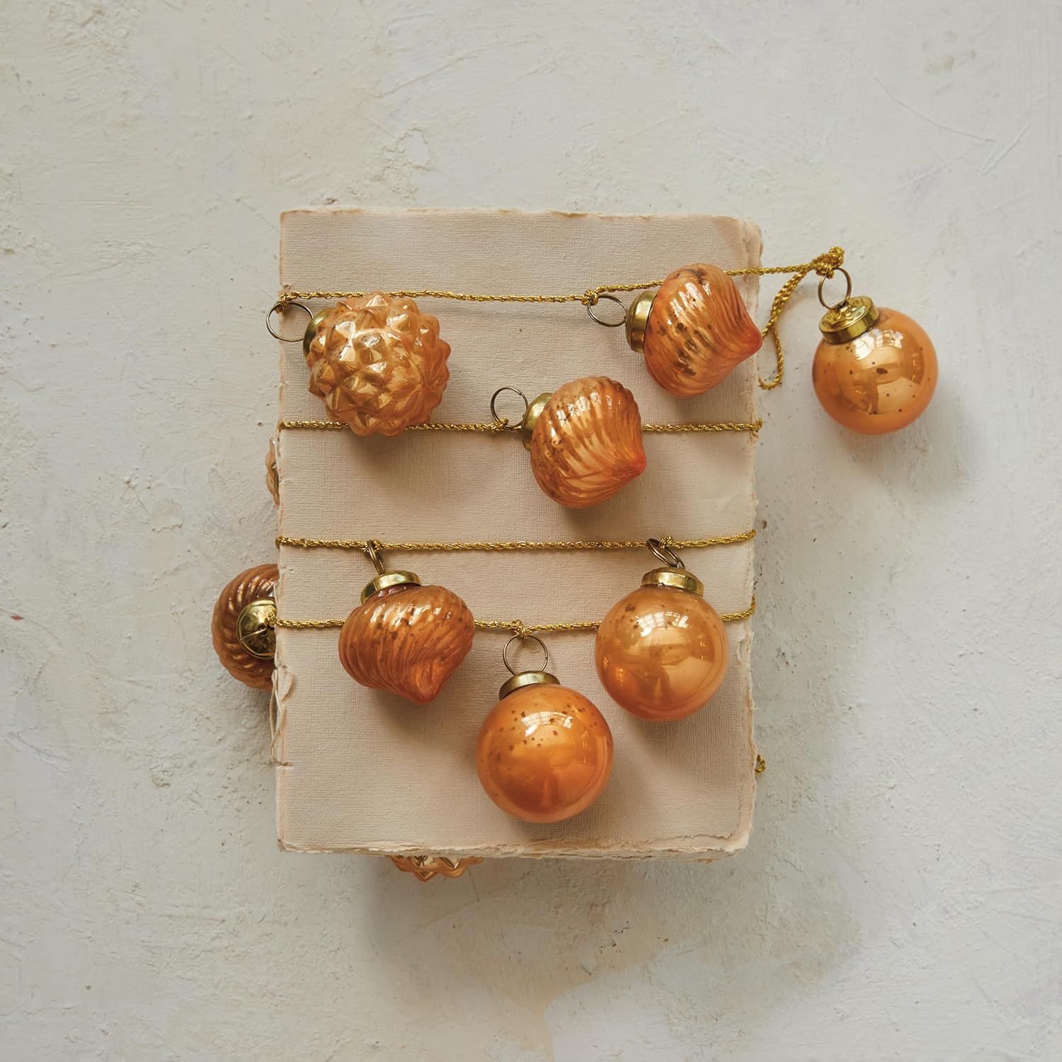 Creative Co-Op Embossed Mercury Glass Ornament Garland on Gold Cord, Apricot Color