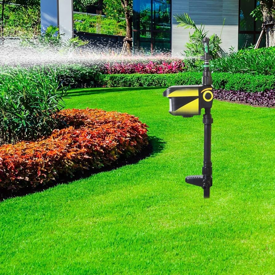 Motion-activated sprinkler watering garden lawn with black and yellow device