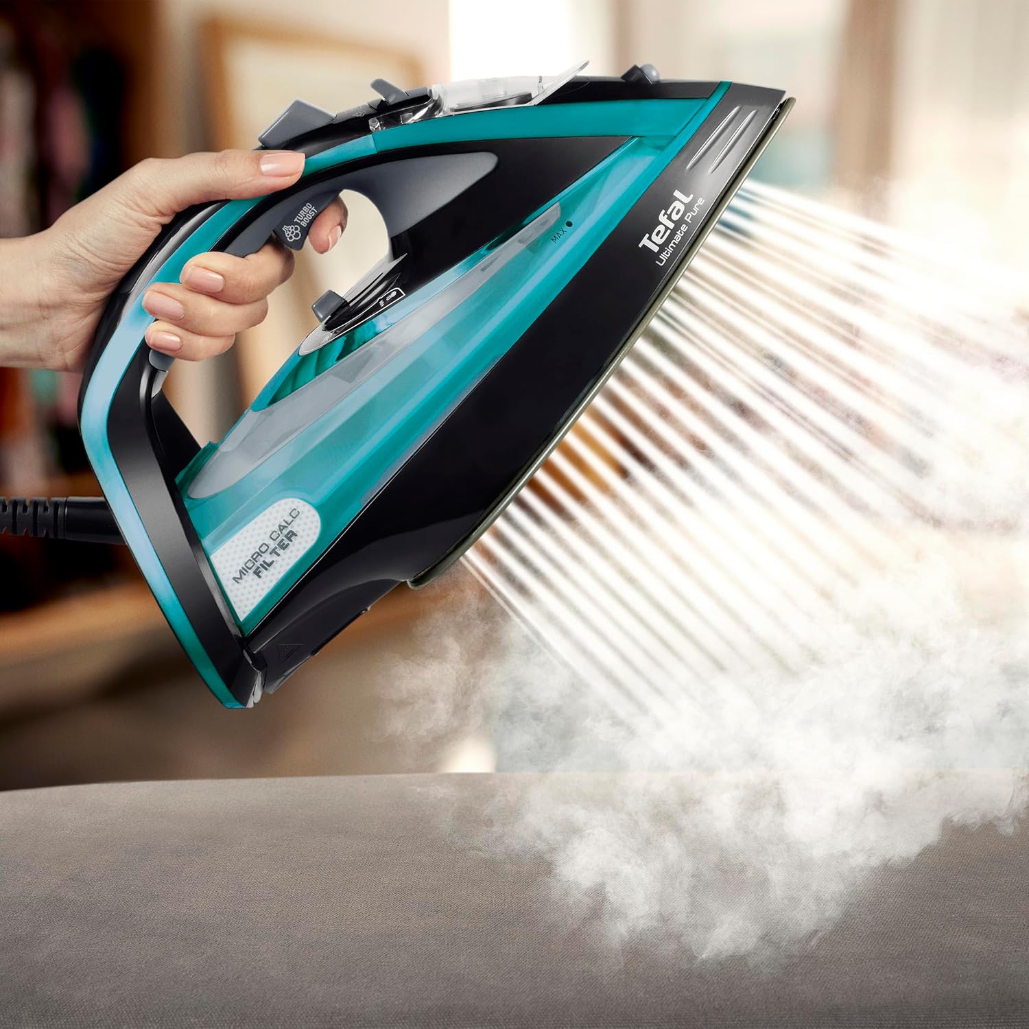 Tefal Ultimate Pure FV9844 steam iron emitting powerful steam during vertical steaming.