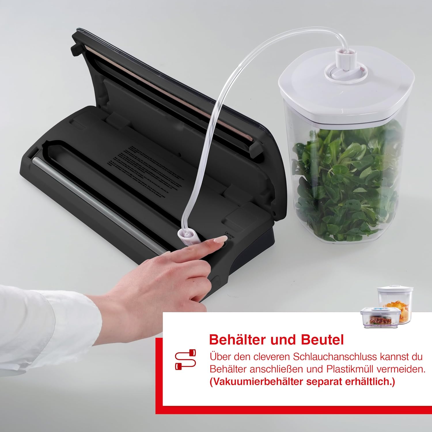 Solis Vac Pro 569 Vacuum Sealing Machine with its lid open, showing a vacuum hose connected to its port and extending to a clear vacuum container filled with herbs, demonstrating container sealing capability.