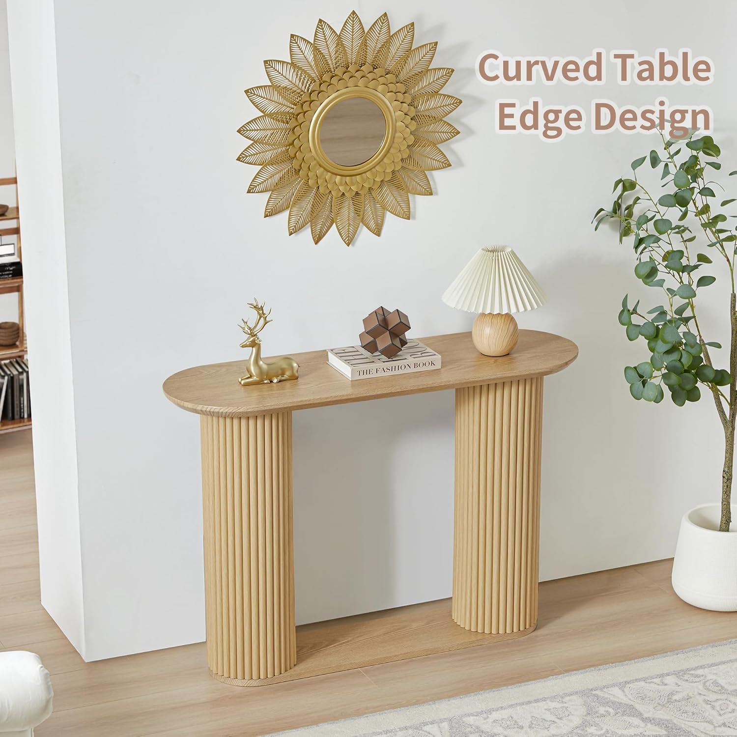 natural fluted console table styled above with mirror and lamp