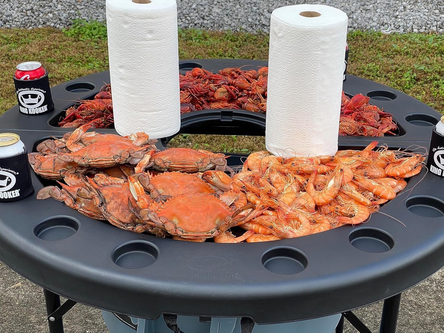 King Kooker Plastic Seafood Serving Table. 42" Diameter and 38" Max Height. Fold Out Legs. Three Height Adustments. Includes Two Paper Towel Holders, Beverage Can Place Holders. Easy to Clean.
