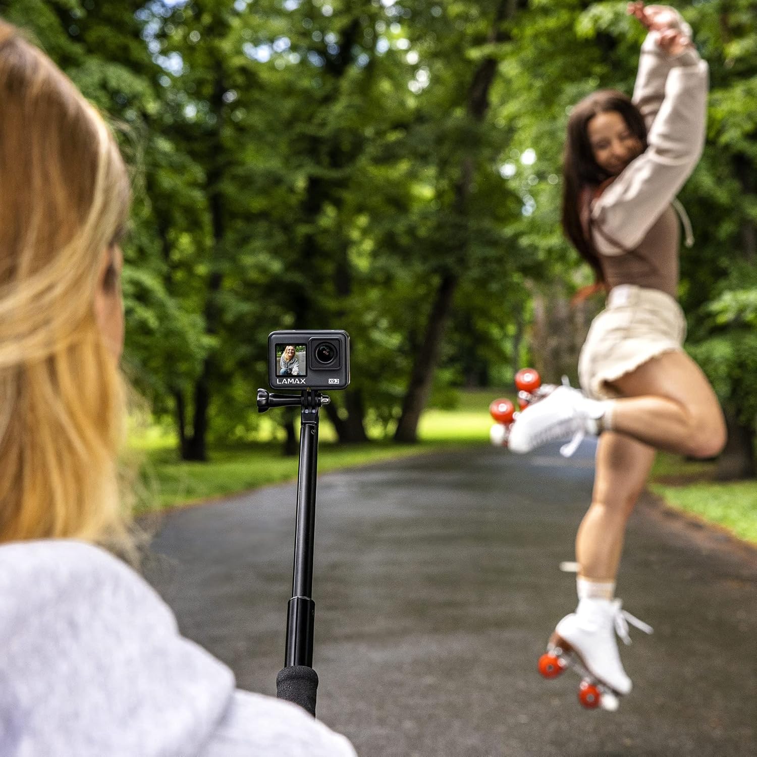 Person filming another person with LAMAX X9.2 on a selfie stick