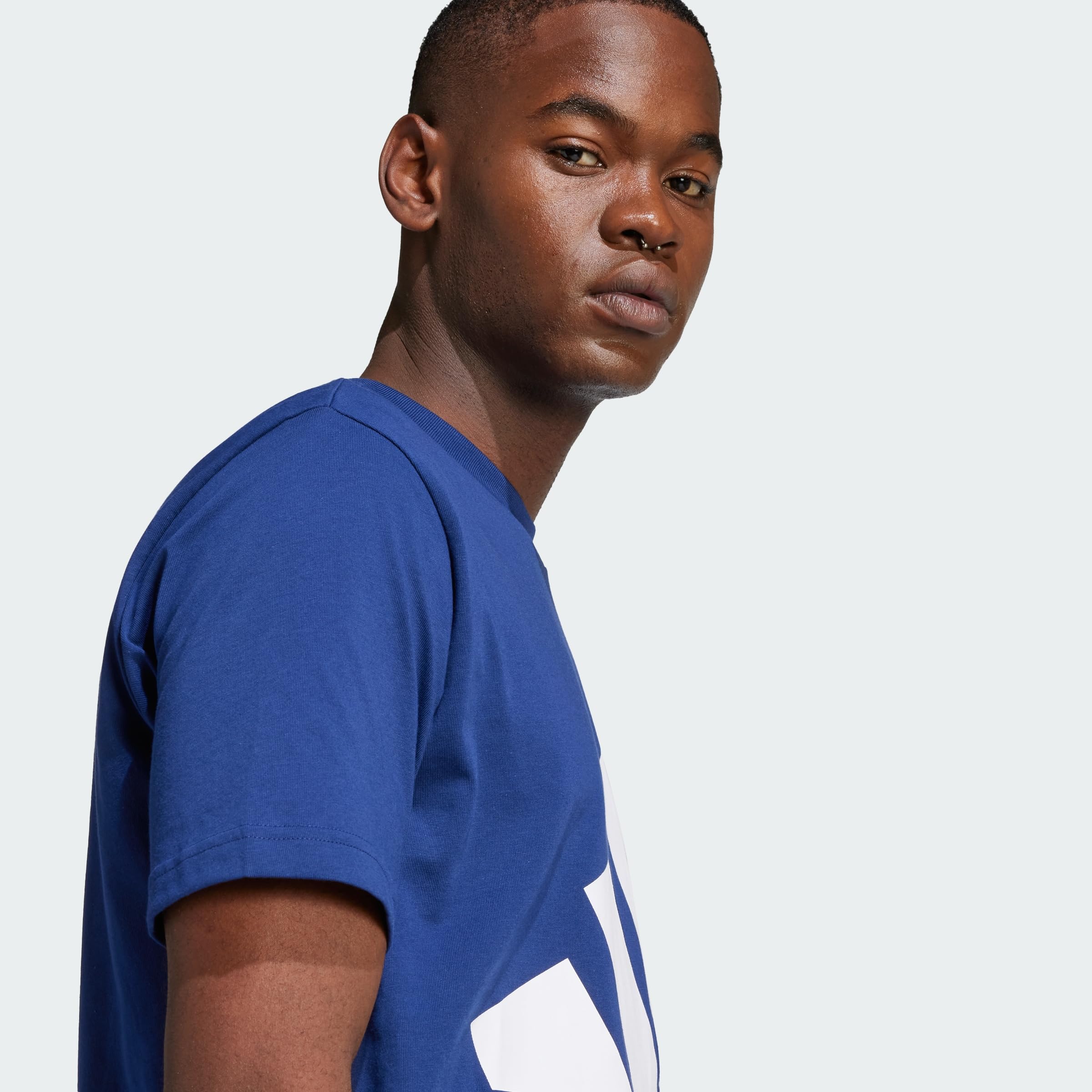 Primer plano del logo grande de Adidas en la camiseta Essentials.