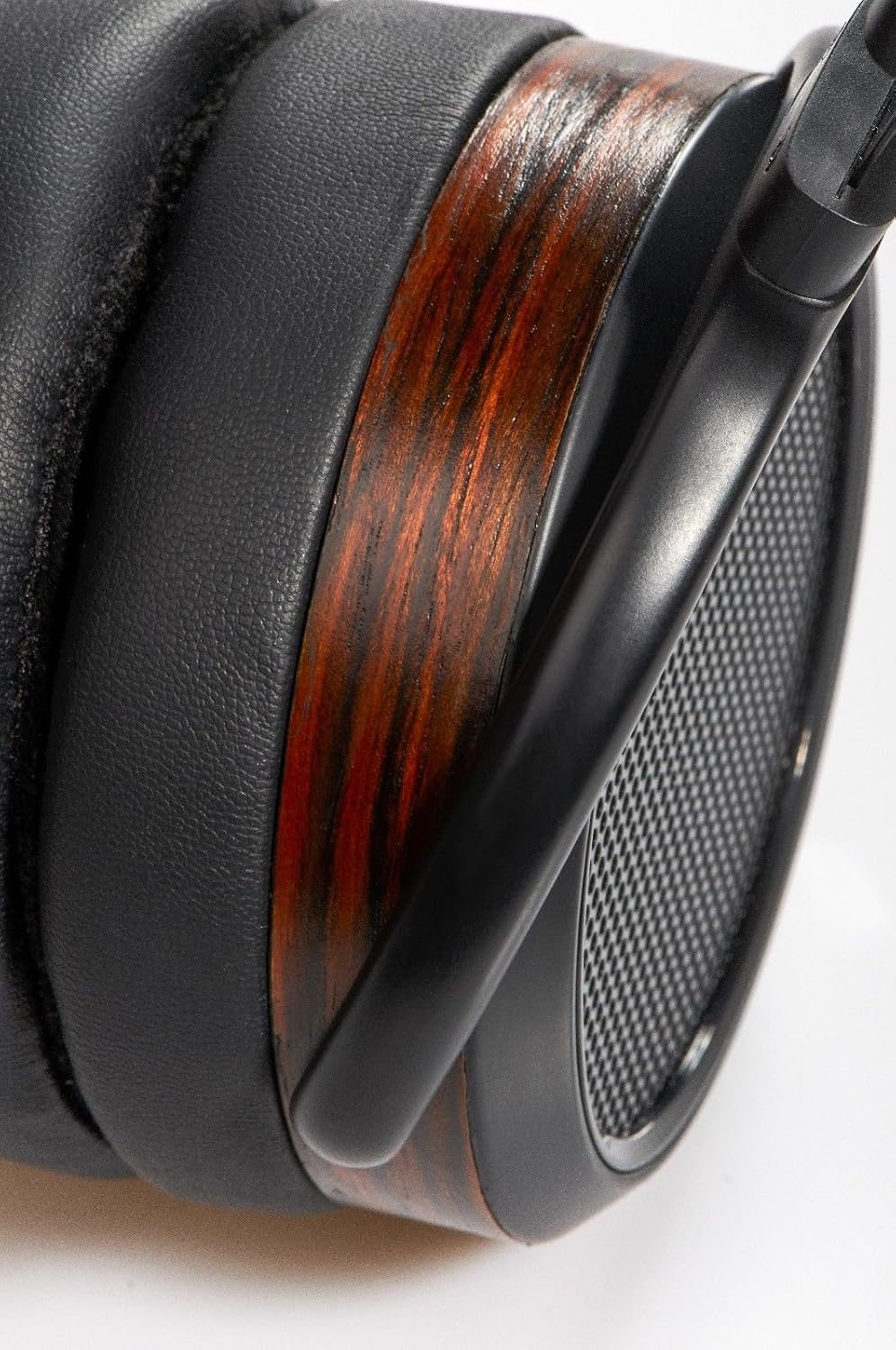 Close-up of HIFIMAN HE560 earcup with woodgrain finish