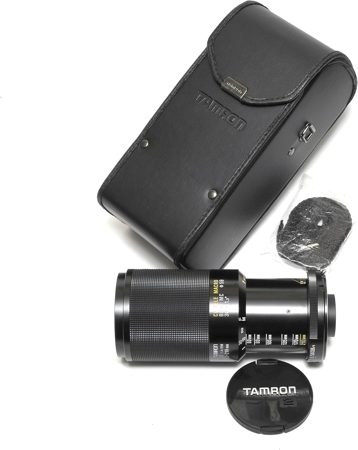 Tamron 80-210mm lens extended to its telephoto setting, with its carrying case and front lens cap.
