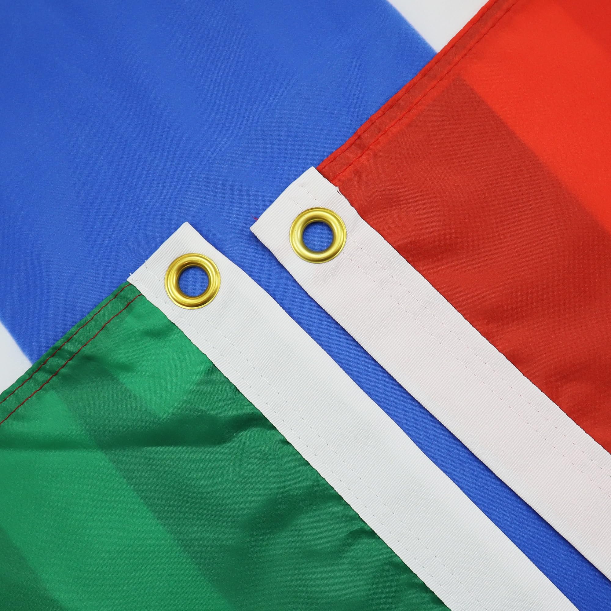 Close-up of the AZ FLAG Gambia flag's brass eyelet and reinforced stitching.
