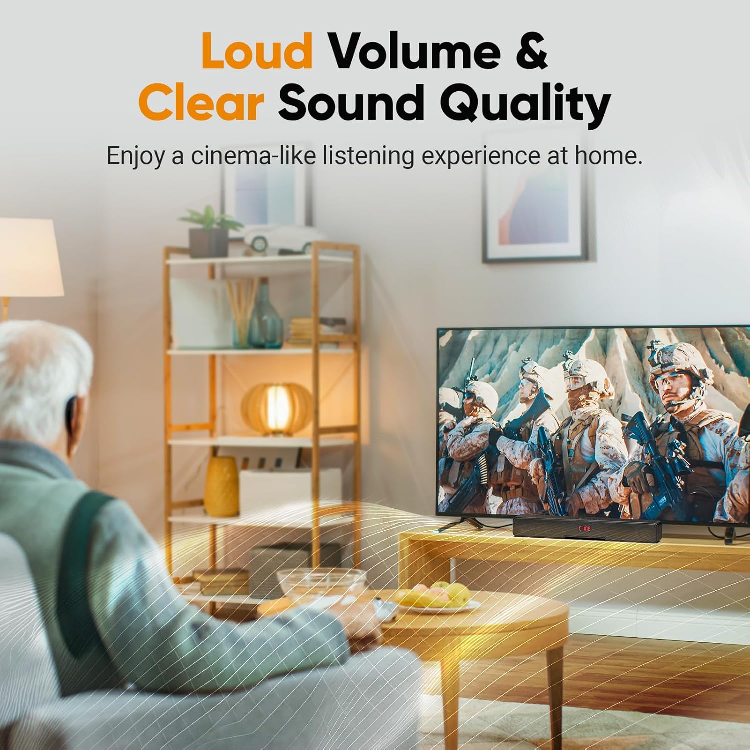 A person sitting on a couch watching TV with the sound bar placed below the television, illustrating the sound bar's use in a home entertainment setup.