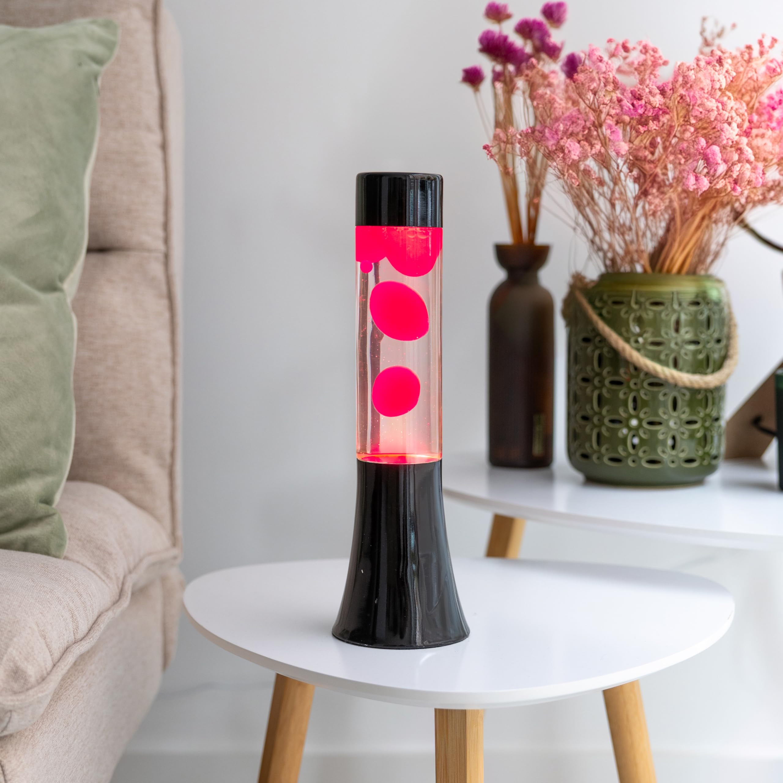Fisura - Różowa lampa lawa. Lampa lawa o wysokości 30 cm z czarną podstawą, różową lawą i przezroczystym płynem. Relaksująca lampa. 9x9x30 cm