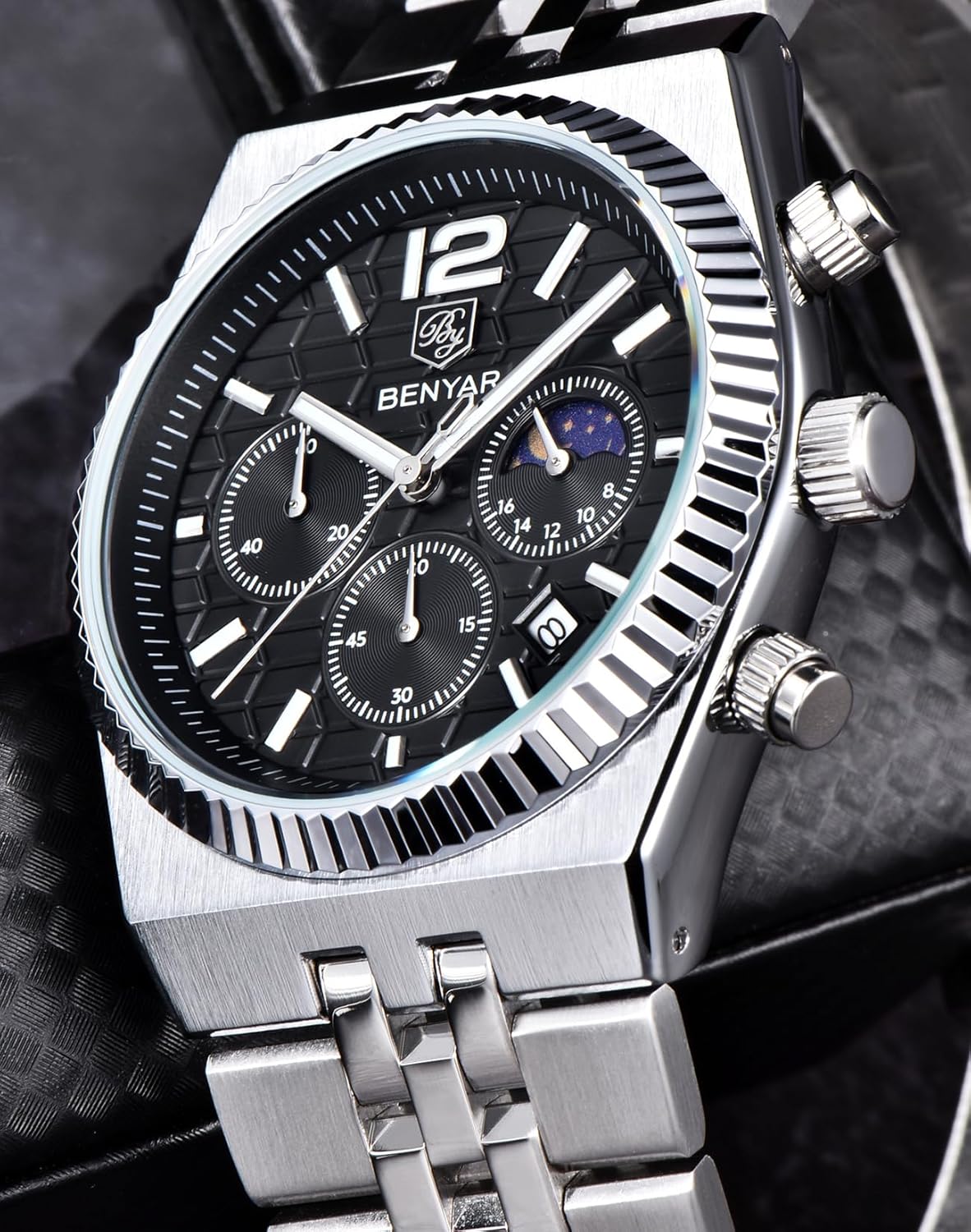 Close-up view of the BENYAR BY-5225 men's chronograph watch face, showing the black textured dial, silver hour markers, luminous hands, three sub-dials, date window, and sun & moon display.