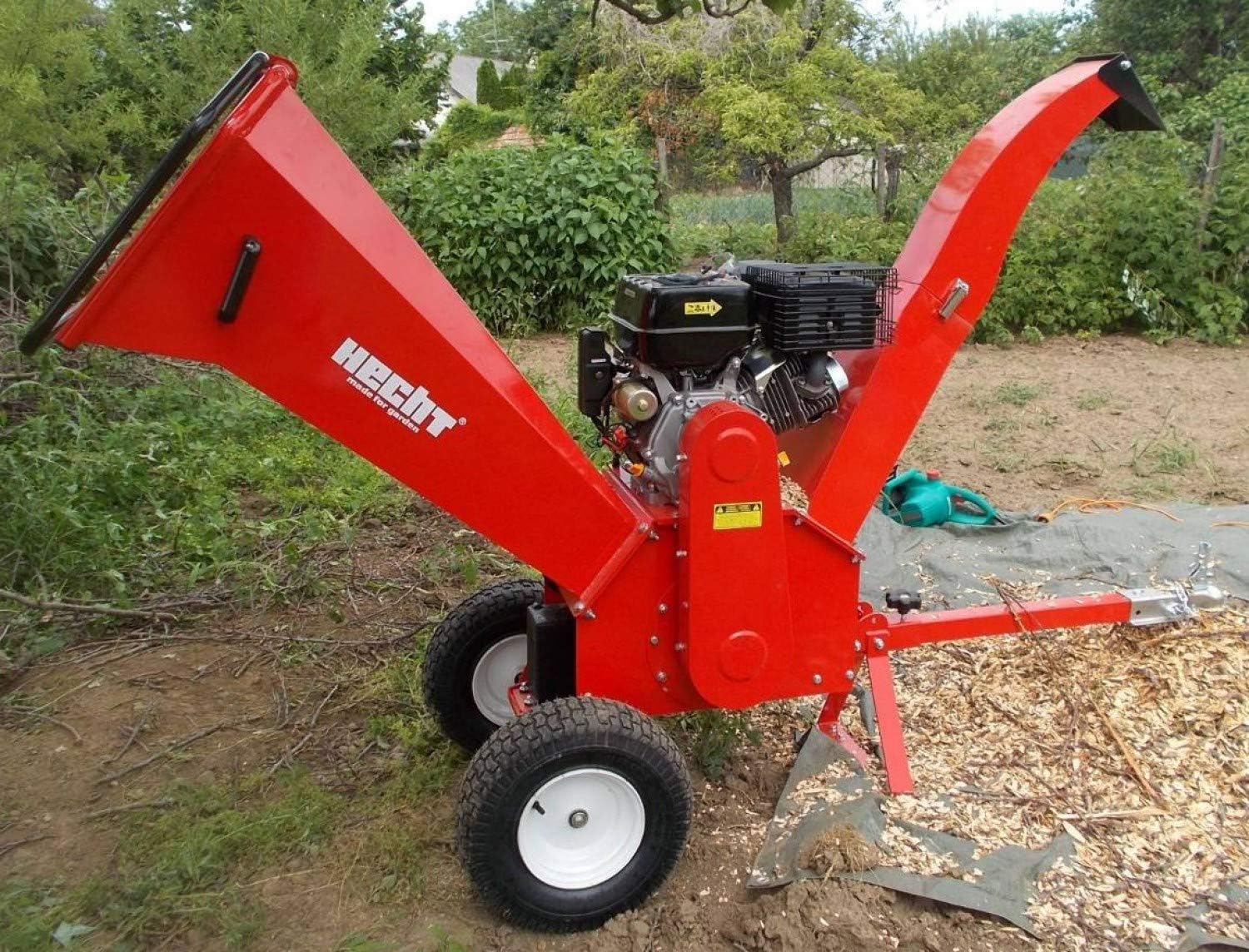 Side view of Hecht 6642 Wood Chipper in operation, showing material being discharged
