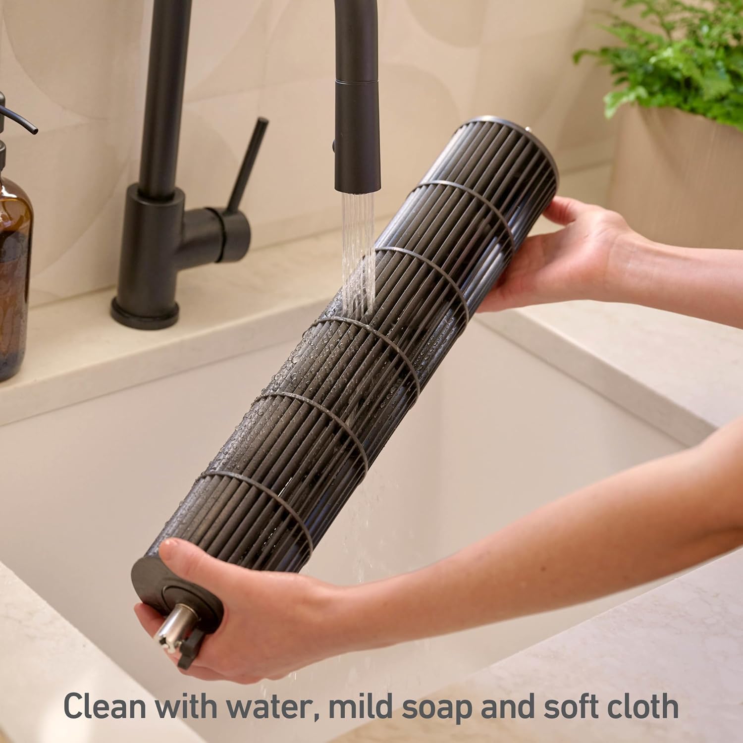 Hand cleaning the fan blade under running water