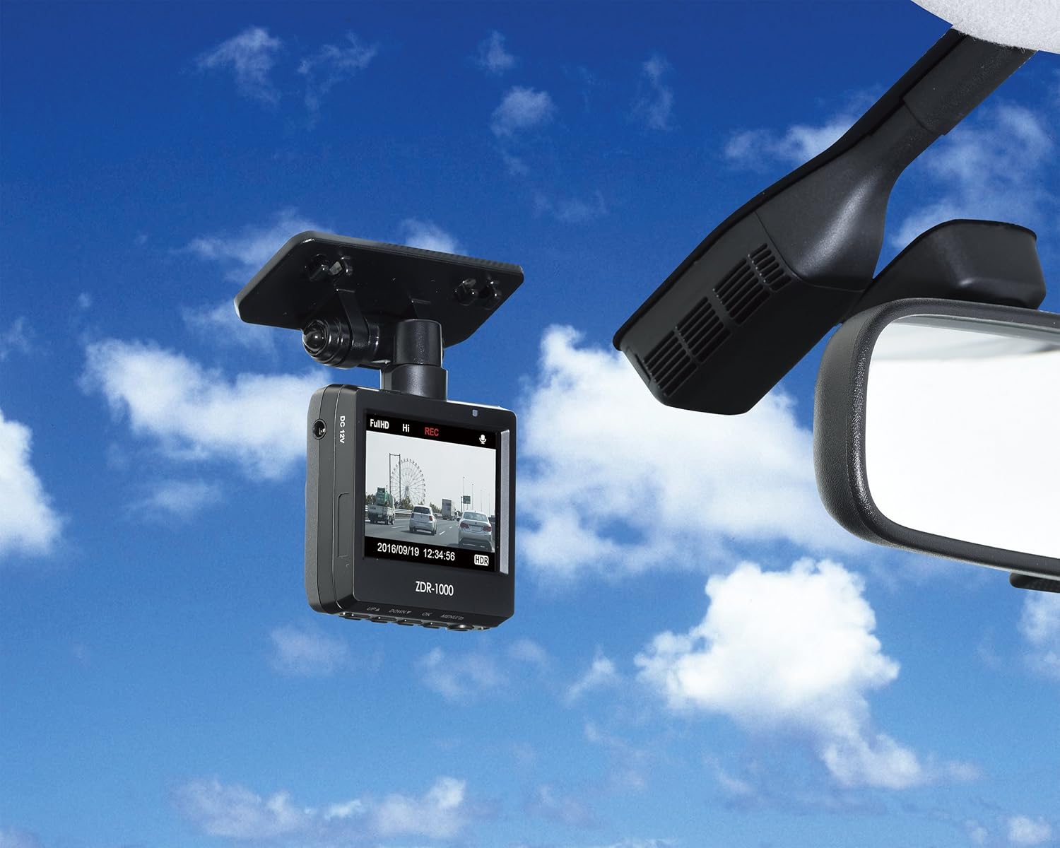 Aldea view of the COMTEC ZDR-012 Drive Recorder installed on a car's windshield, showing its discreet profile.