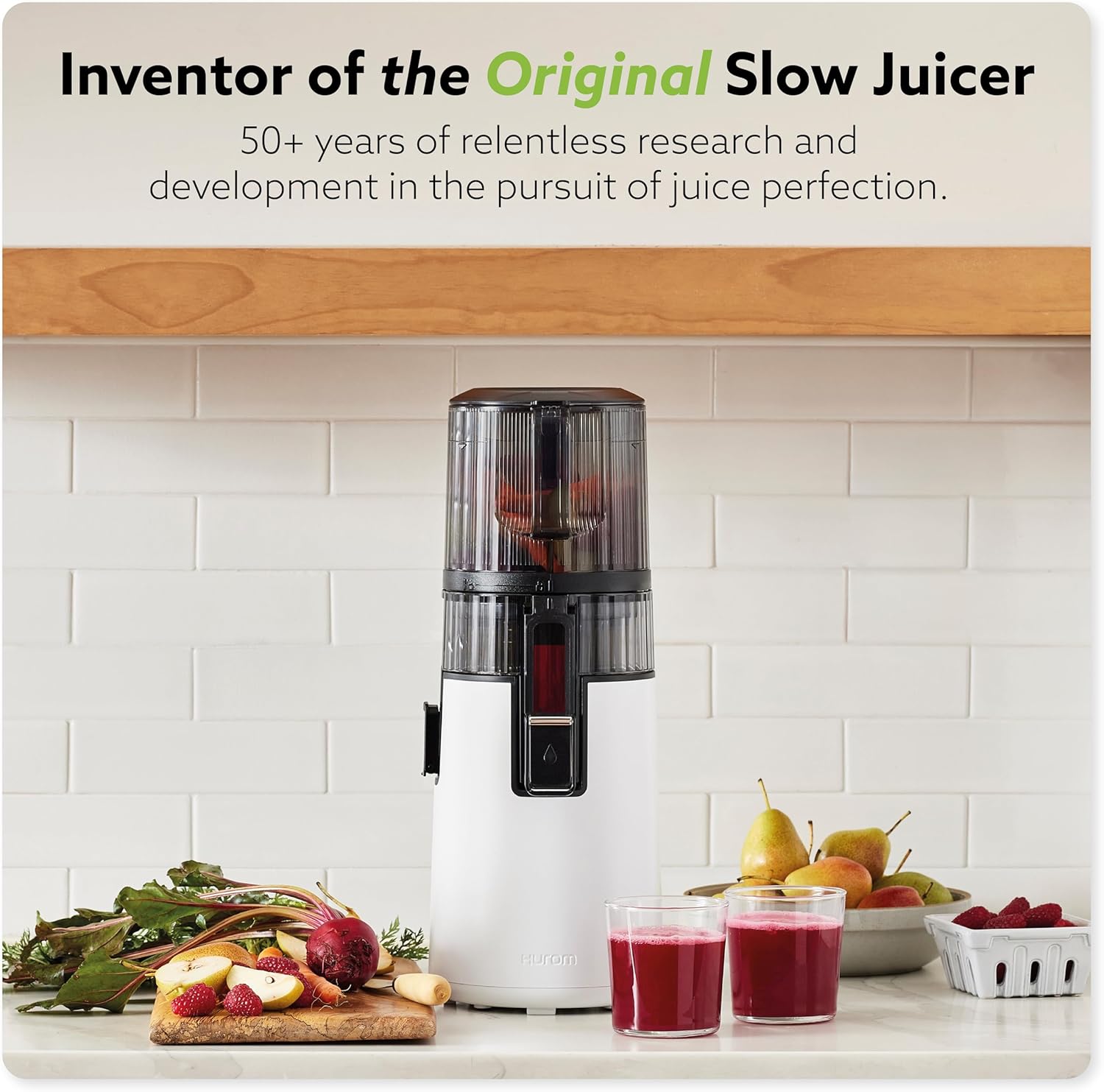 Hands rinsing the disassembled components of the Hurom H70 Juicer under running water in a sink.