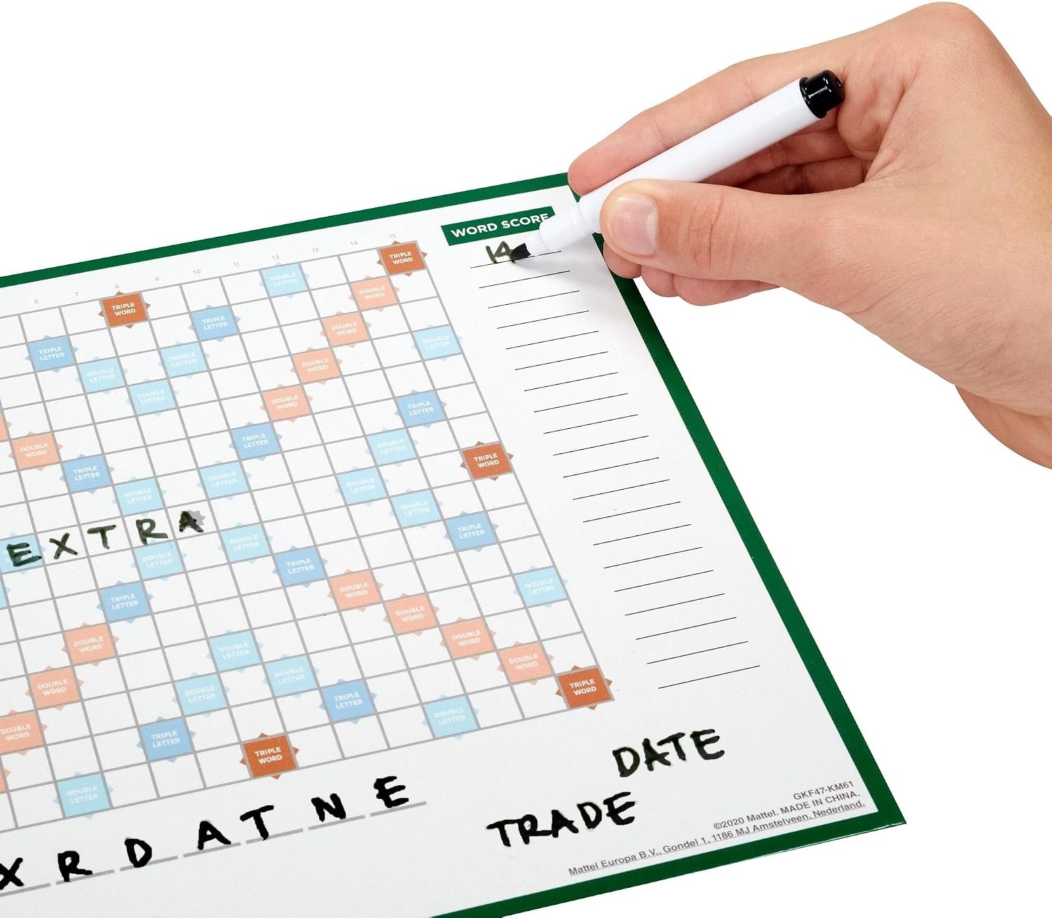A hand using a marker to write a score on a personal player board during a game of Scrabble Duplicate.