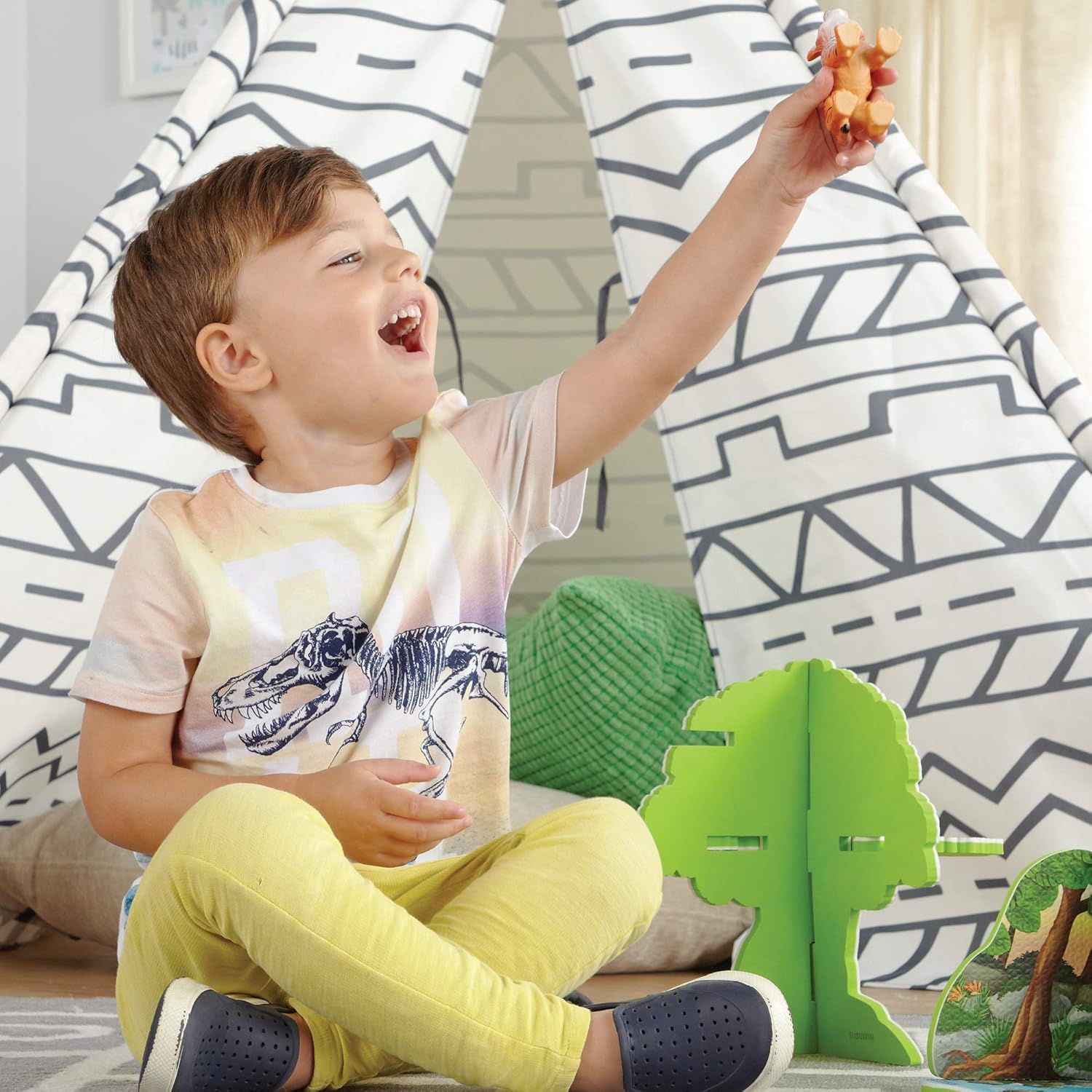 A child happily playing with an animal figure from the playset.