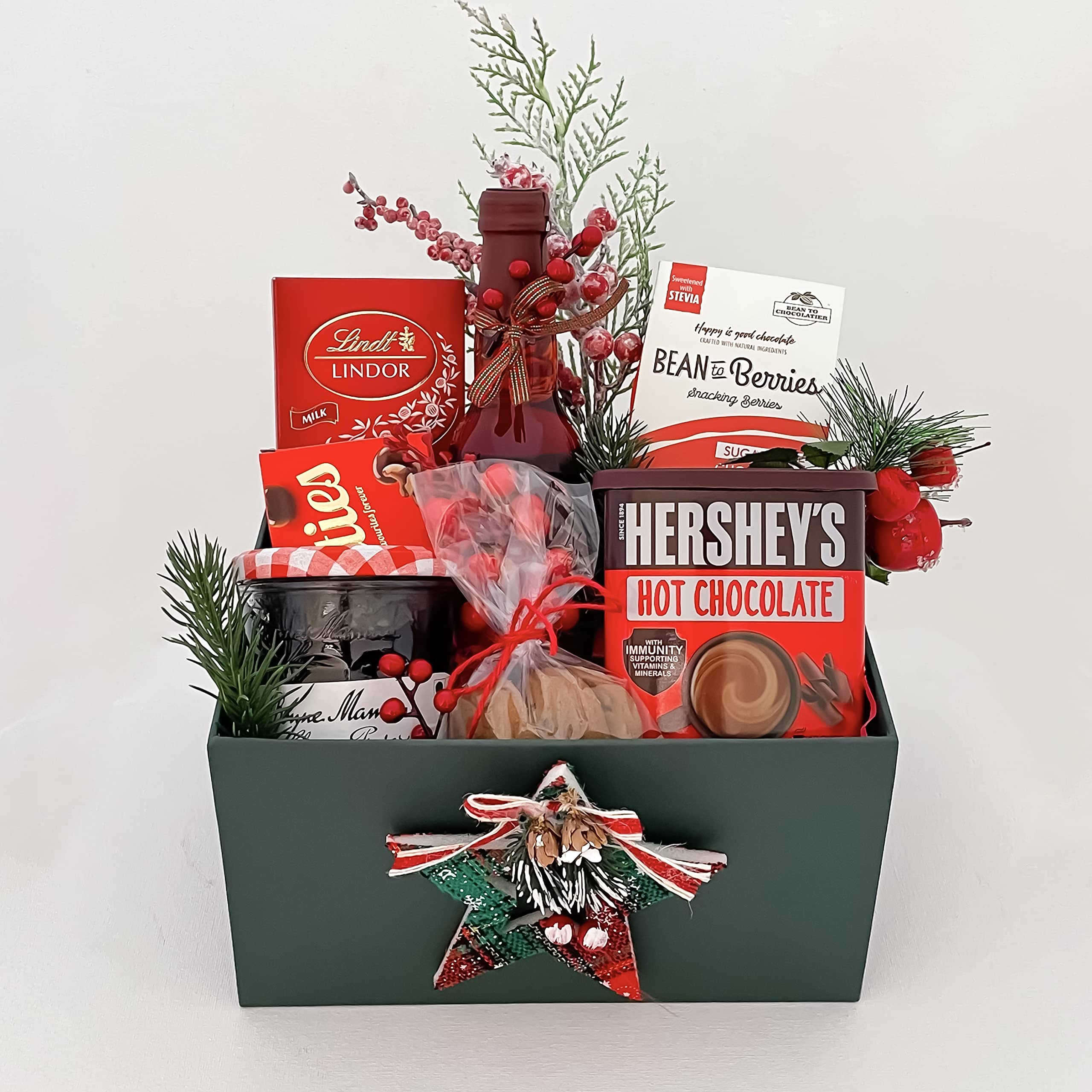 Elegant Christmas gift hamper that encloses Lindt Lindor, Chocolate Coated Cranberries,Sparkling Red Grape Drink,Nutties,Cookies,Jam,Hersheys,Christmas decor and lovely greetings. XMAGB025