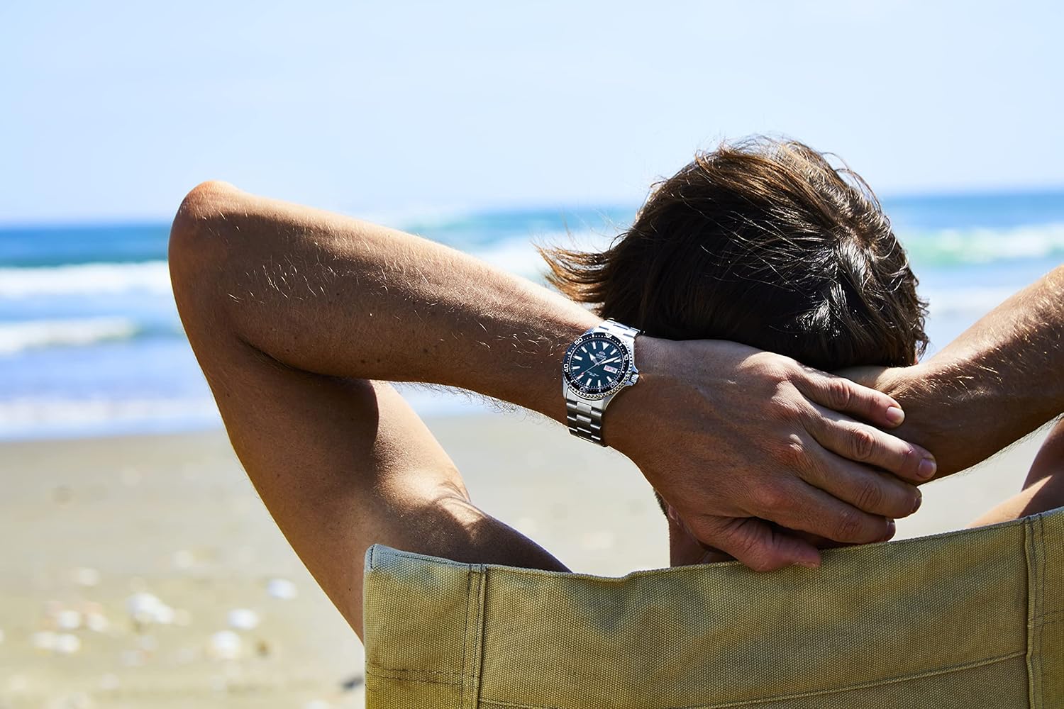 Person wearing watch on a beach