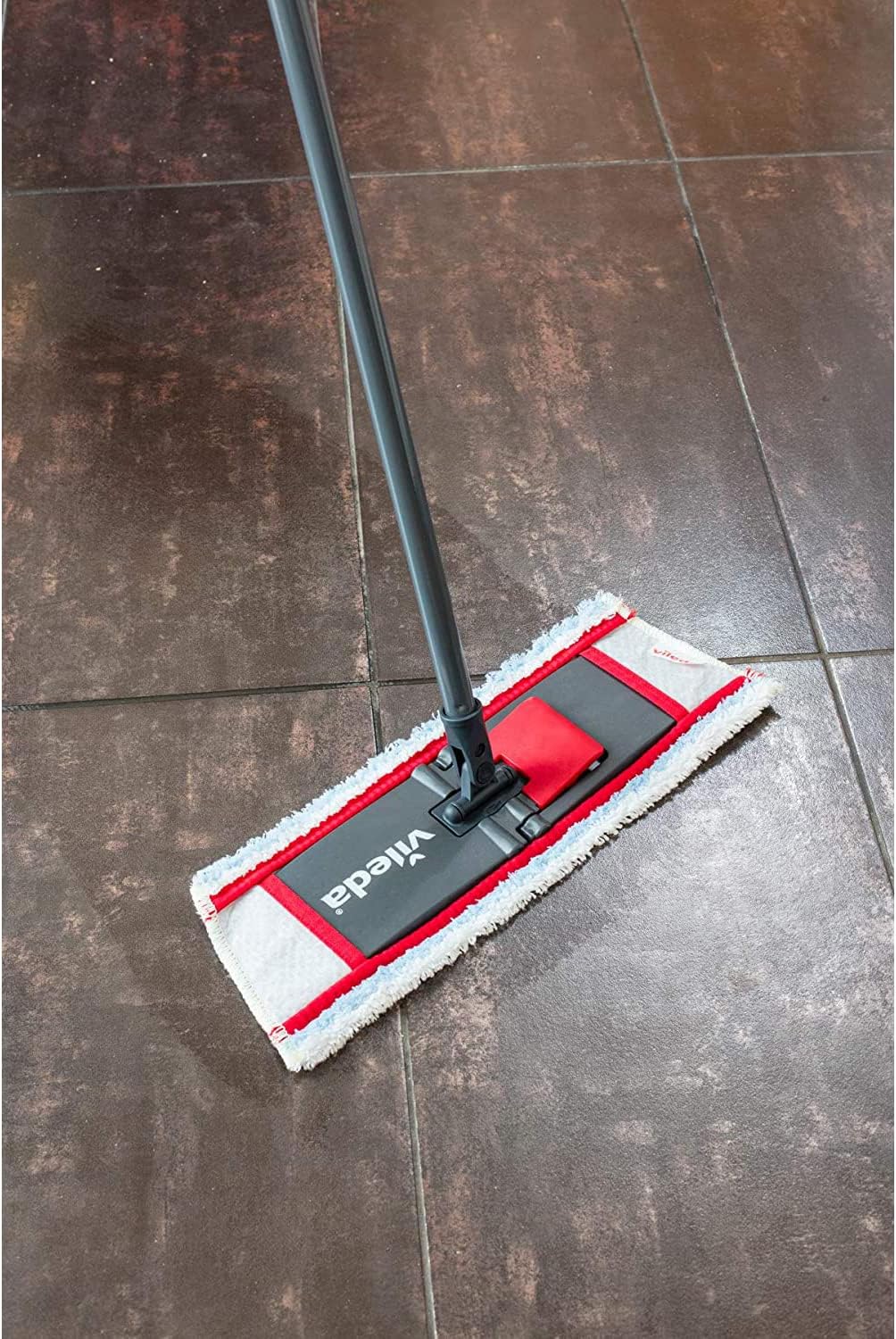 Vileda Lavatutto mop head with blue and white striped cloth on a tiled floor.