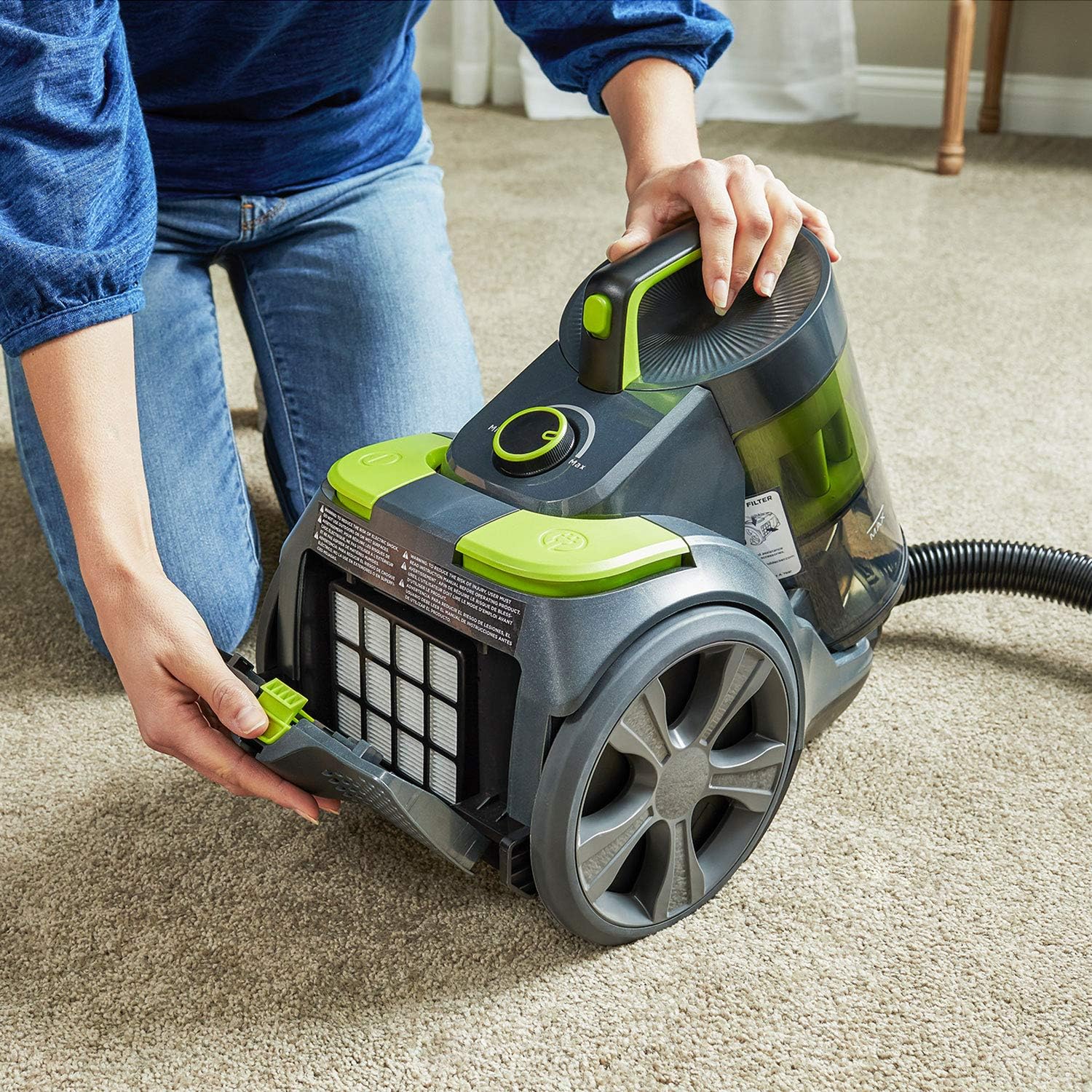 User opening the filter compartment of the BLACK+DECKER BDXCAV217G vacuum