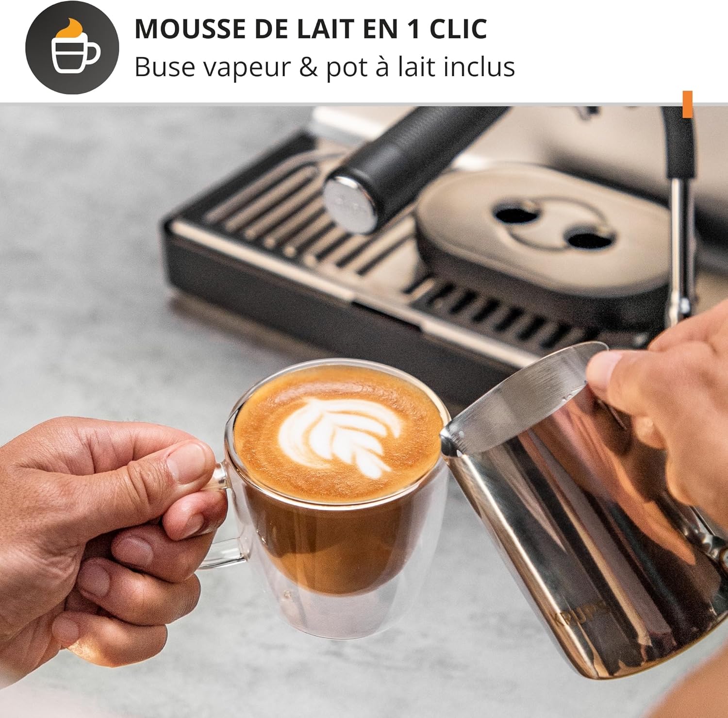 Hand frothing milk with the steam wand of the Krups espresso machine to create latte art.