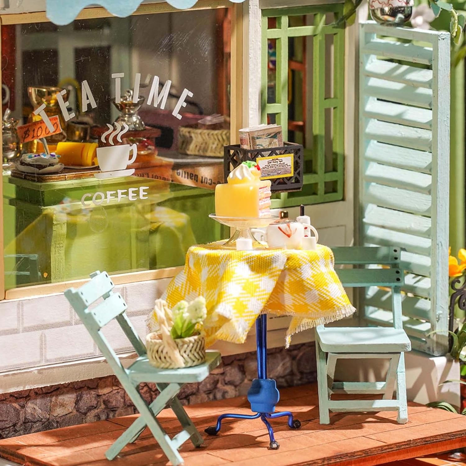 Close-up of the miniature patio area with a table, two chairs, and a small cake