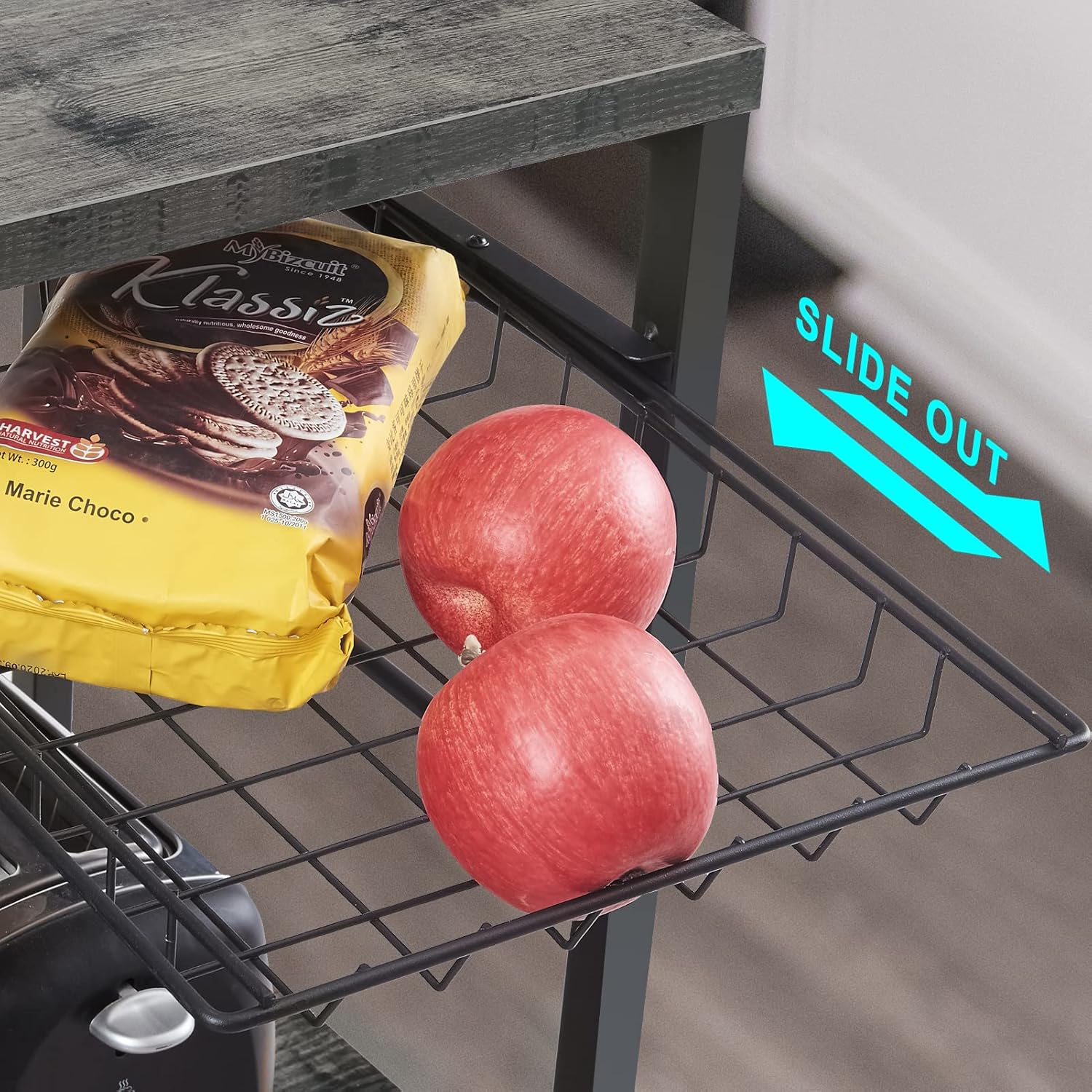Close-up of the slide-out wire basket on the bakers rack, holding fruit