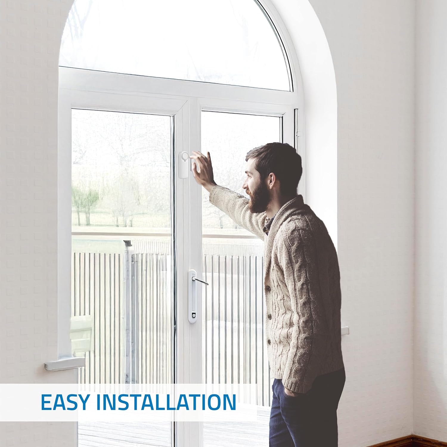 Man installing the Nivian Smart WiFi Door Alarm sensor on a door frame, demonstrating easy installation.