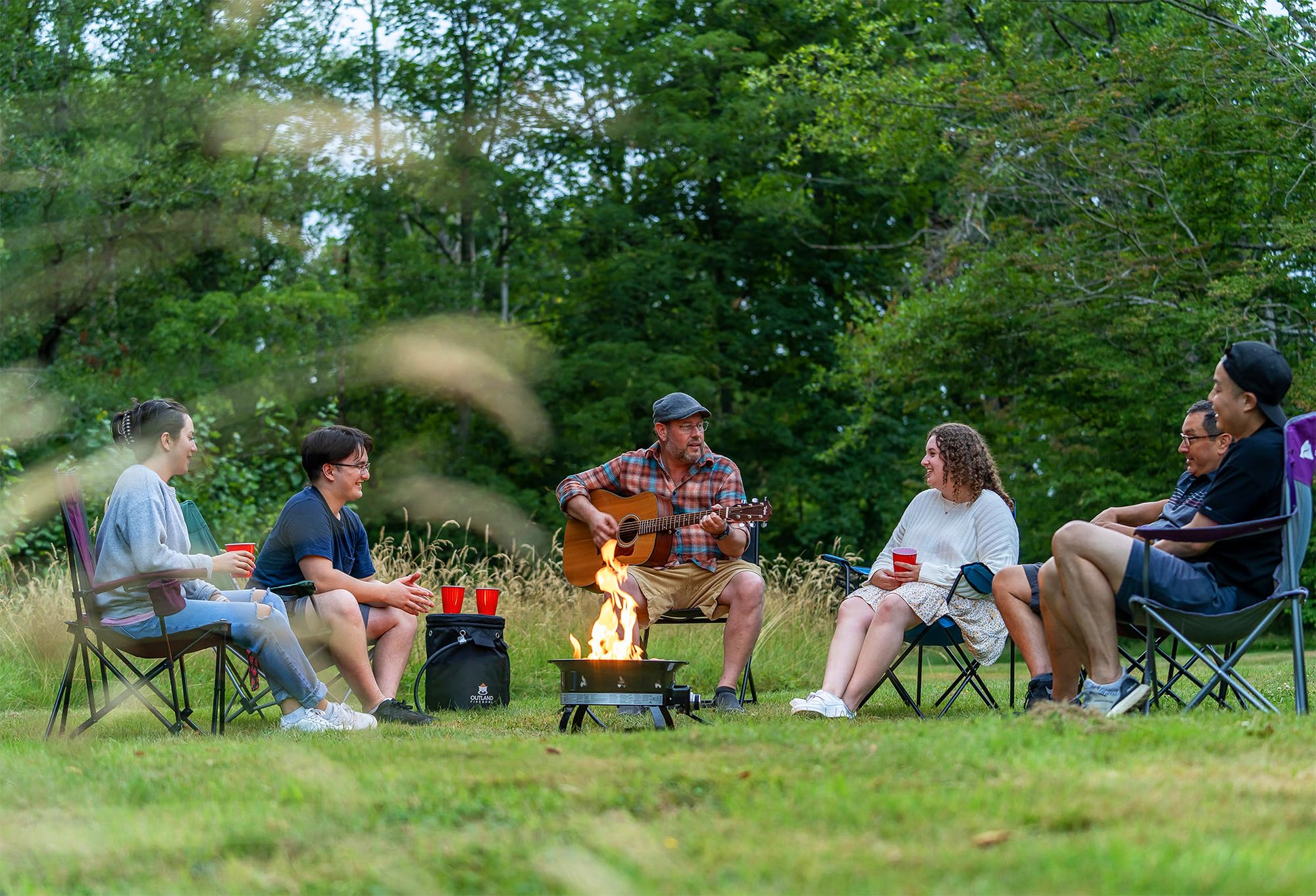 The Outland Living Firebowl 823 providing a warm, inviting glow with its lava rocks and adjustable flame.