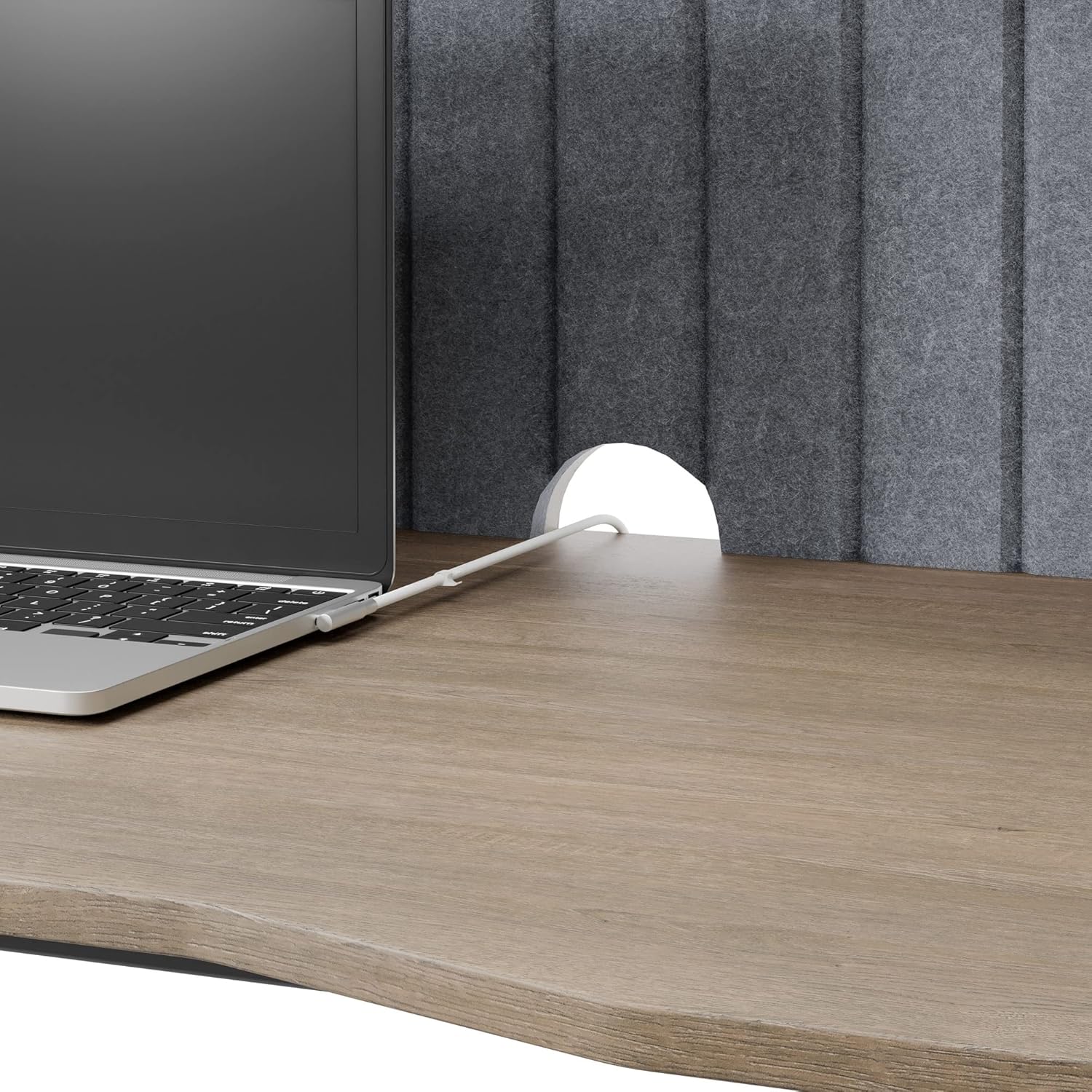 Close-up view of the cable management cutout located in the hutch of the Realspace Nashira Desk, with a power cord passing through.