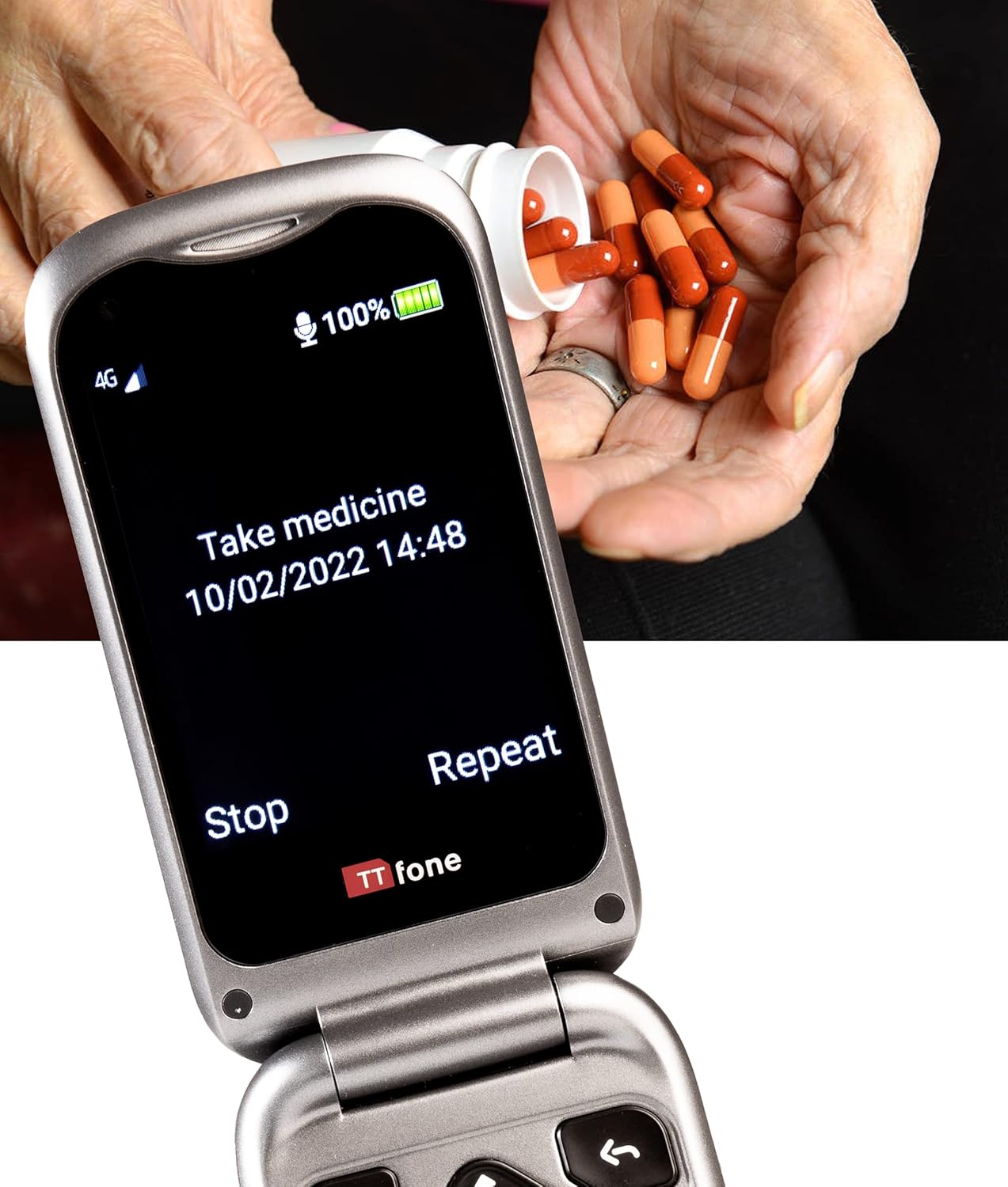 TTfone TT970 phone screen showing 'Take medicine' reminder, with pills in background