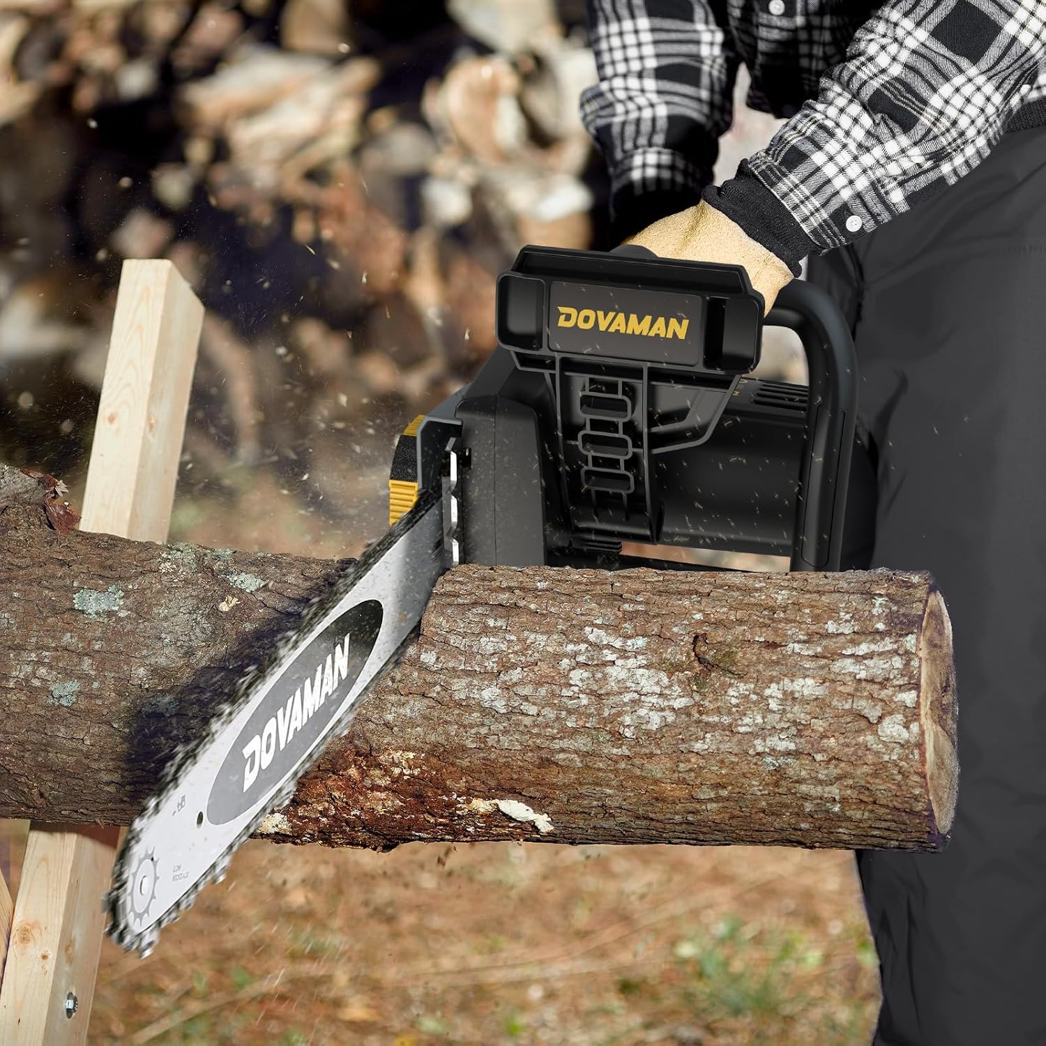 Person using the DOVAMAN electric chainsaw to cut a large log