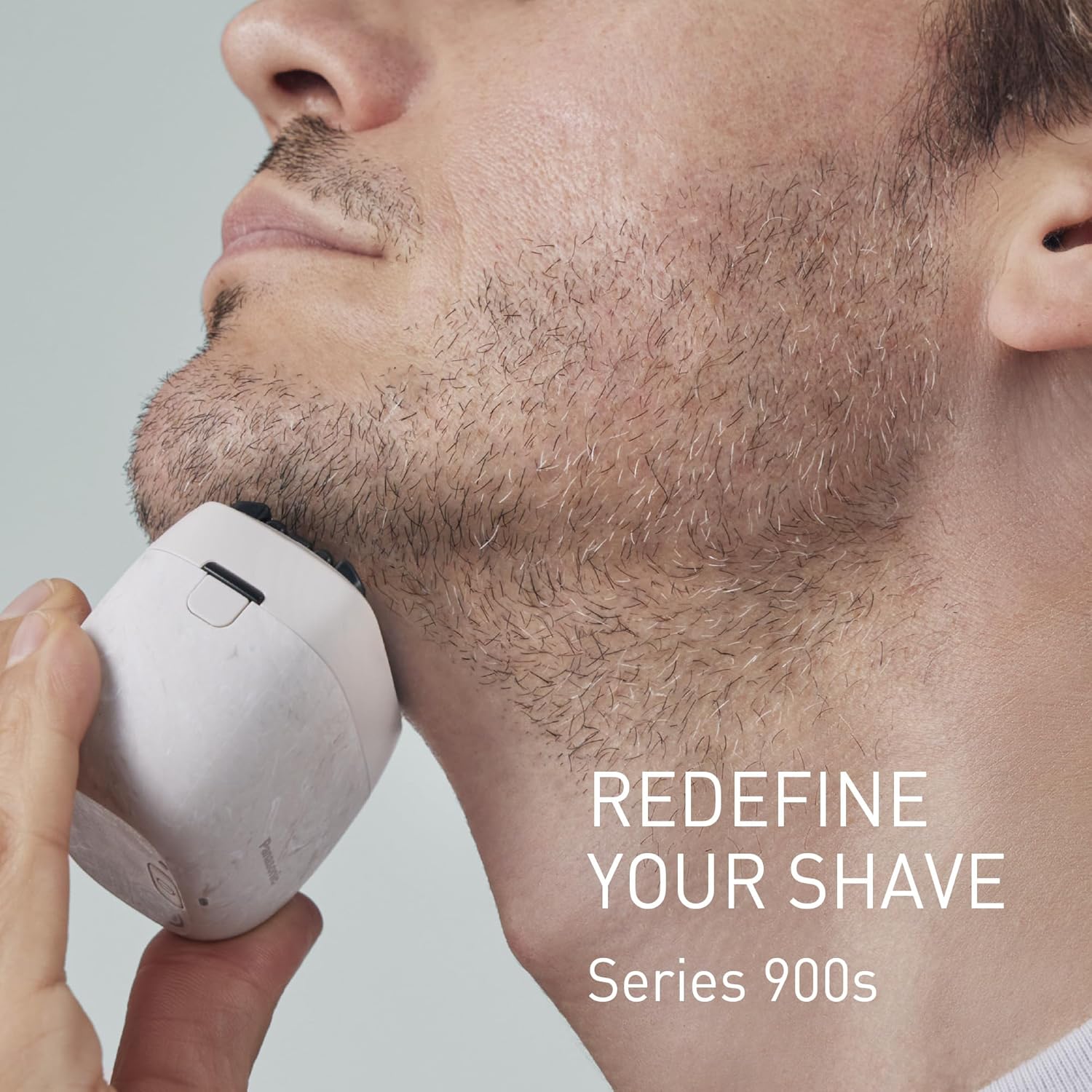 Man shaving with Panasonic Series 900s electric shaver, highlighting the compact design and close shave.