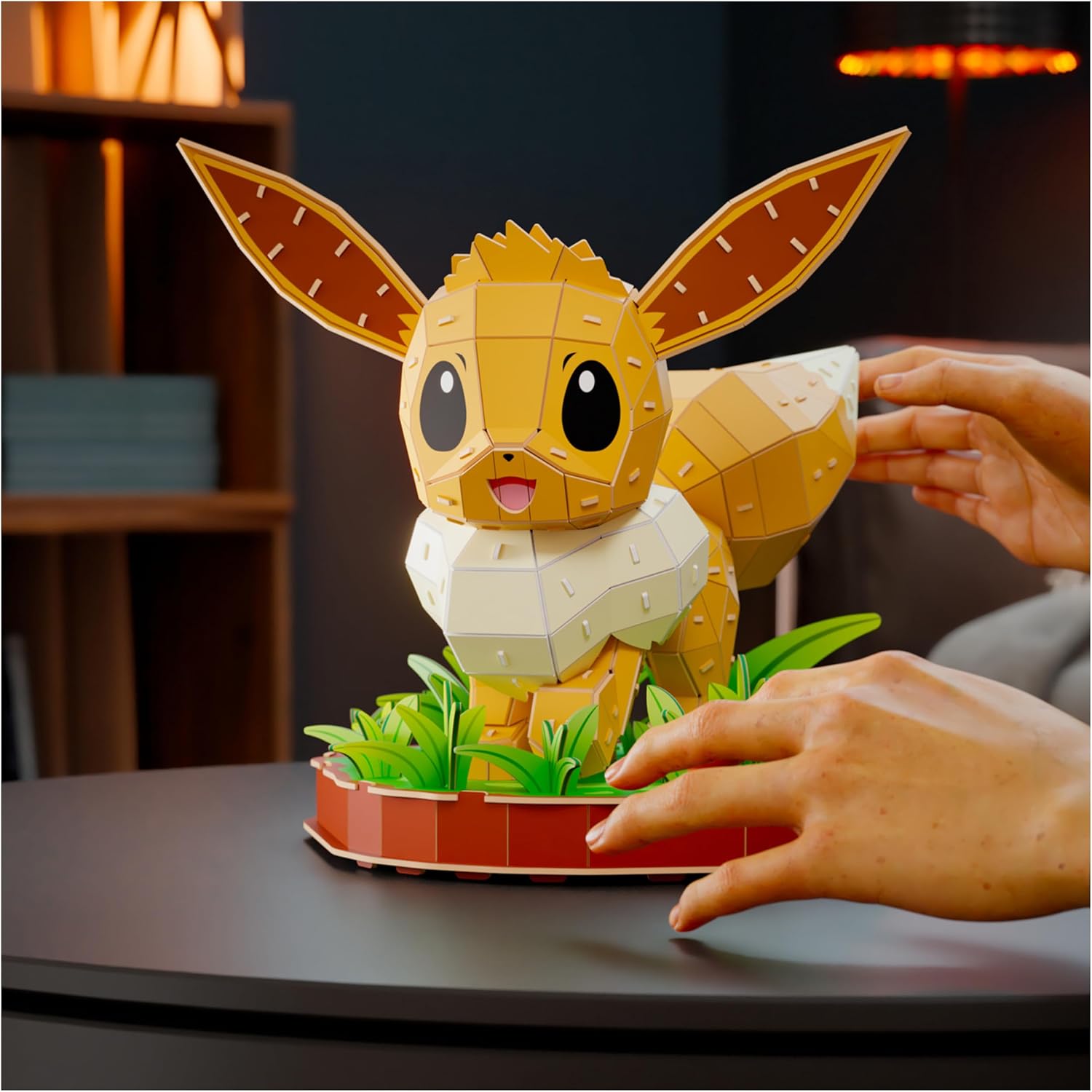Hands assembling the Eevee model