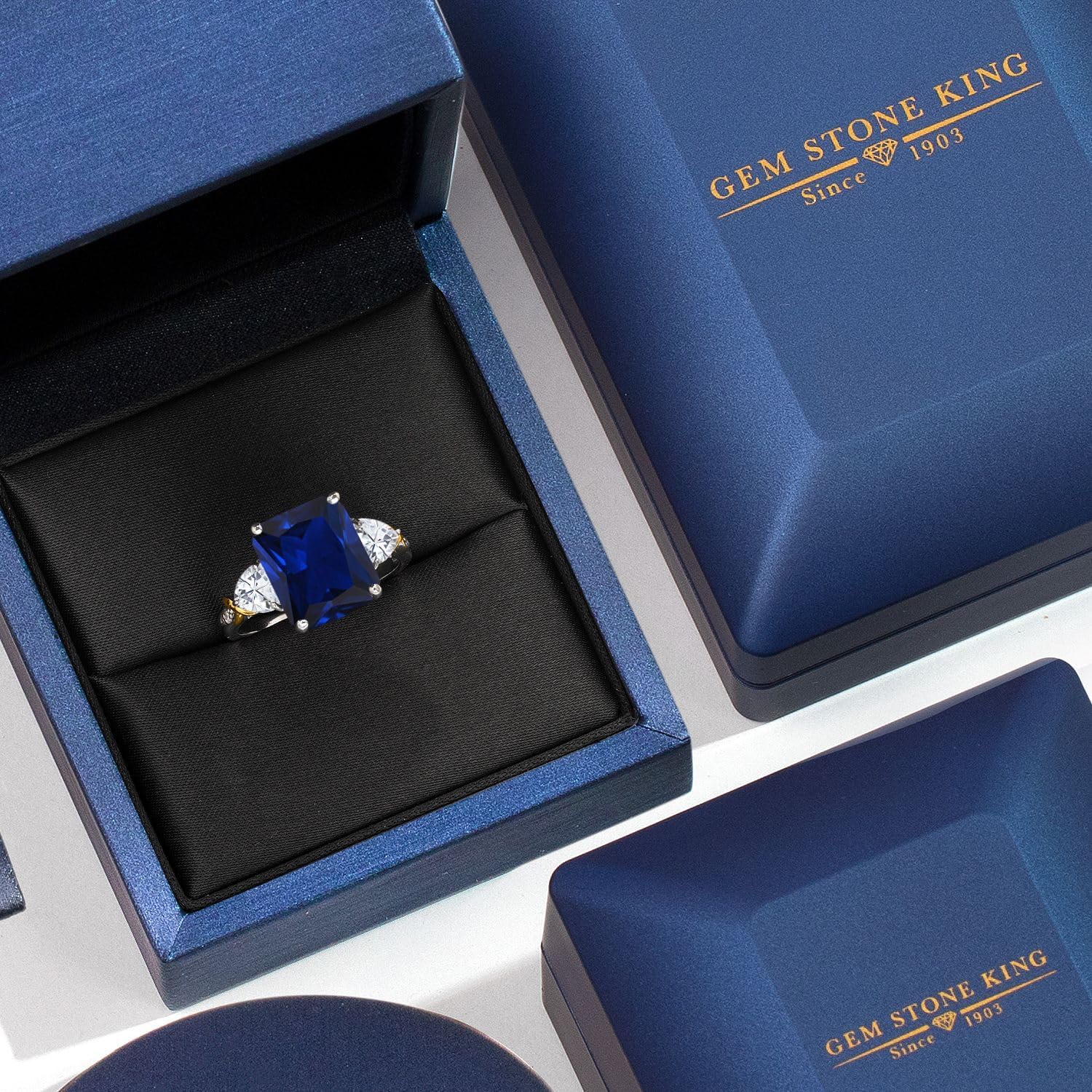 Gem Stone King 7.66 Cttw Blue Simulated Sapphire Moissanite and Diamond 3-Stone Ring For Women | 925 Silver and 10K Yellow Gold | Gemstone Birthstone | 12X10MM Emerald Cut and 5MM Trillion