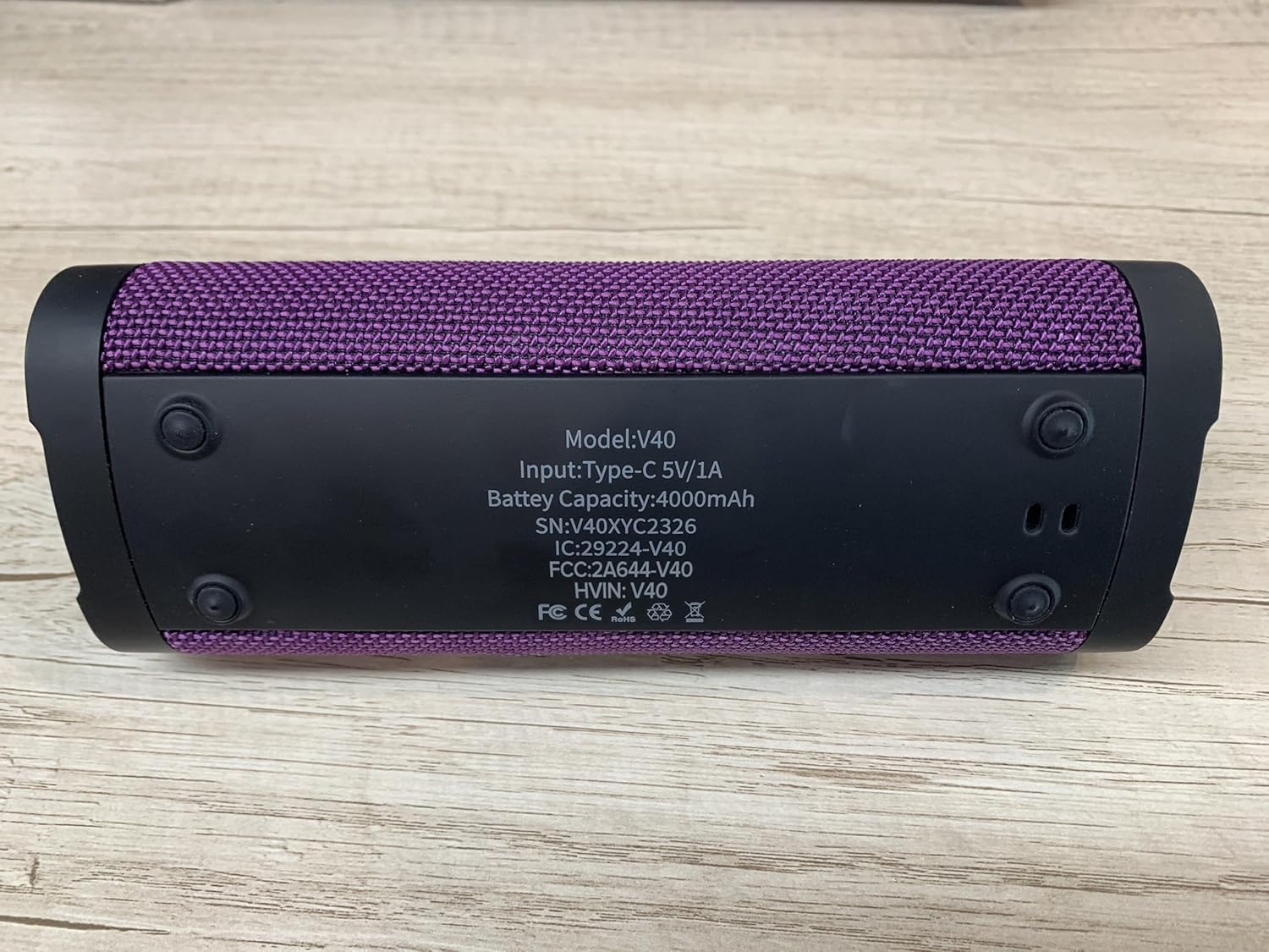 Vanzon V40 speaker partially submerged in water, demonstrating IPX7 waterproofing.