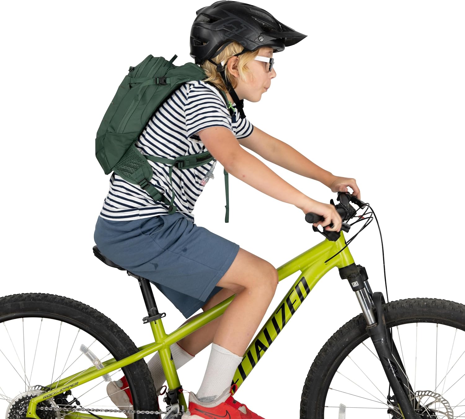 Child wearing Osprey Raptor Jr backpack with a full-face helmet attached