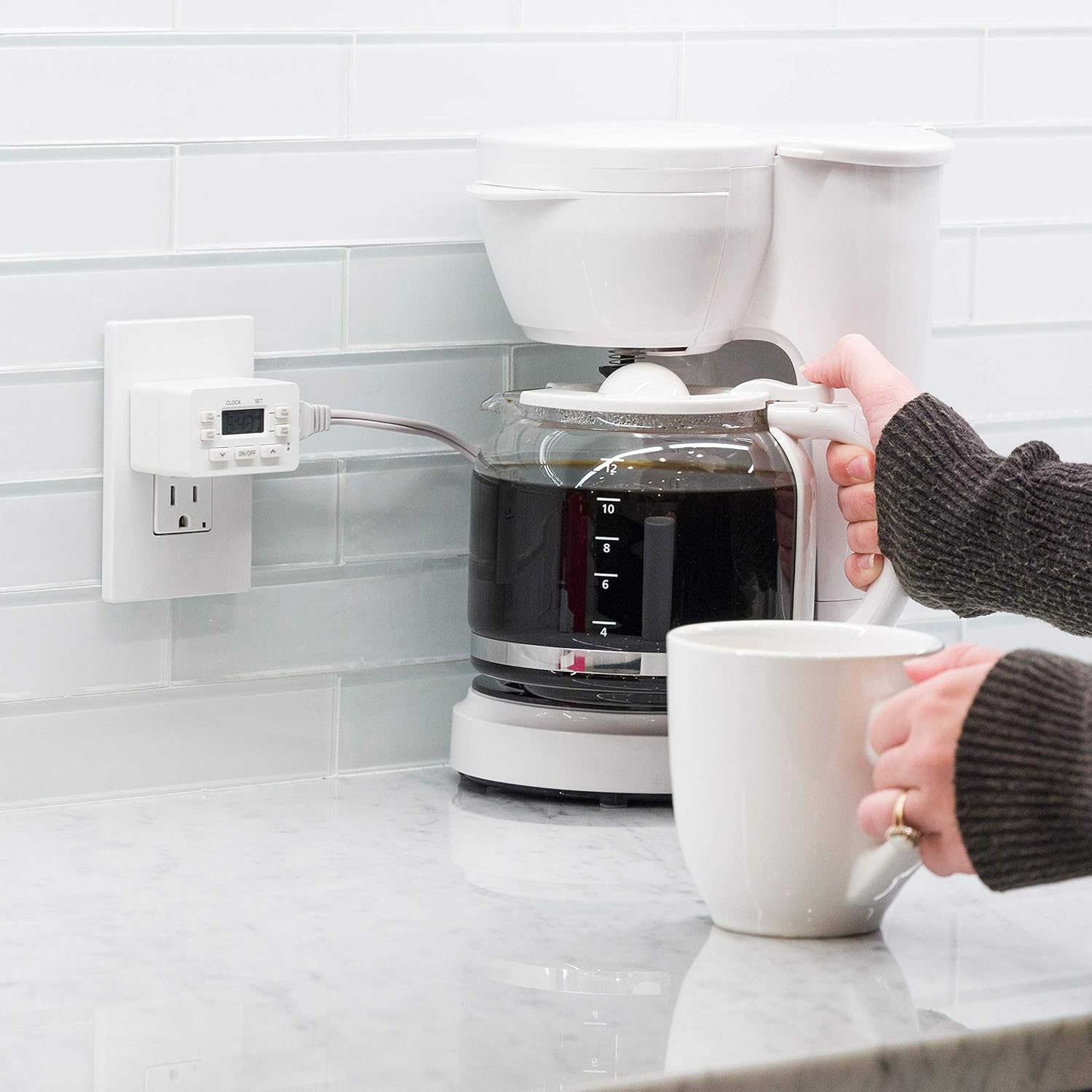 UltraPro Digital Timer plugged into a wall outlet, controlling a coffee maker on a kitchen counter.