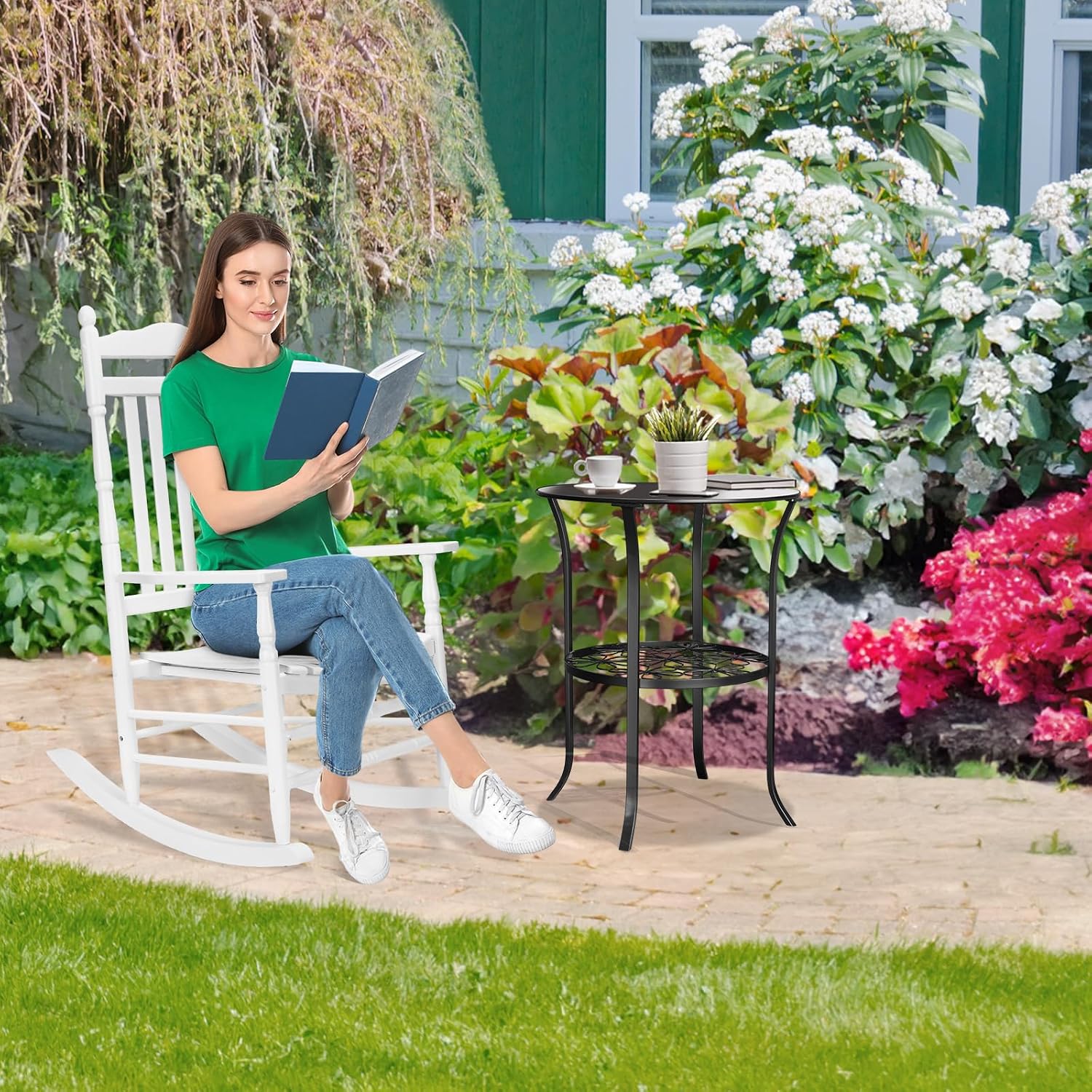 Woman reading a book in a VINGLI rocking chair in a garden setting