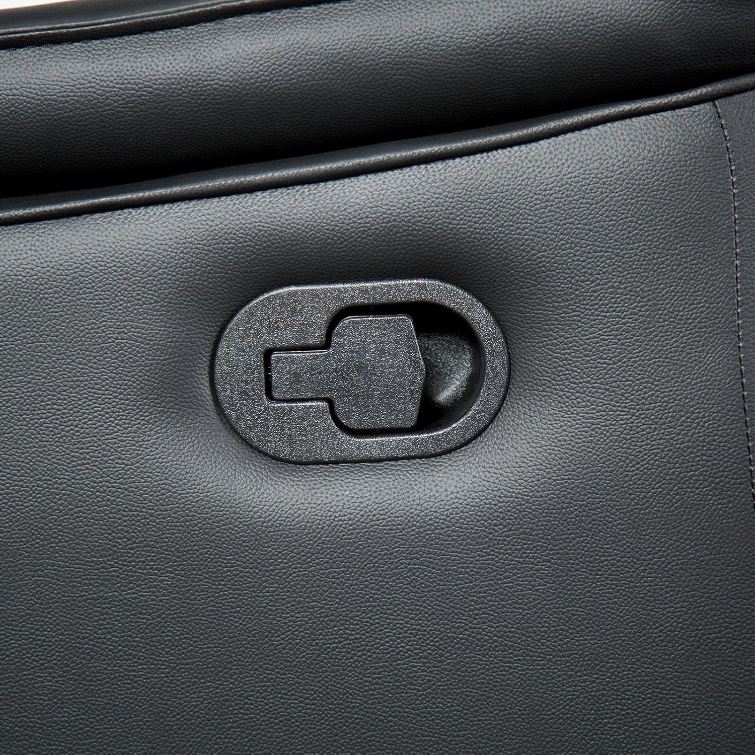 Close-up of the manual recliner handle on a black leather chair