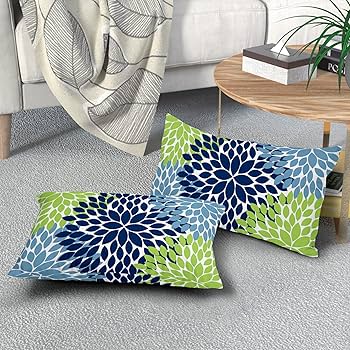 teal and sage green decorative pillows on white sofa