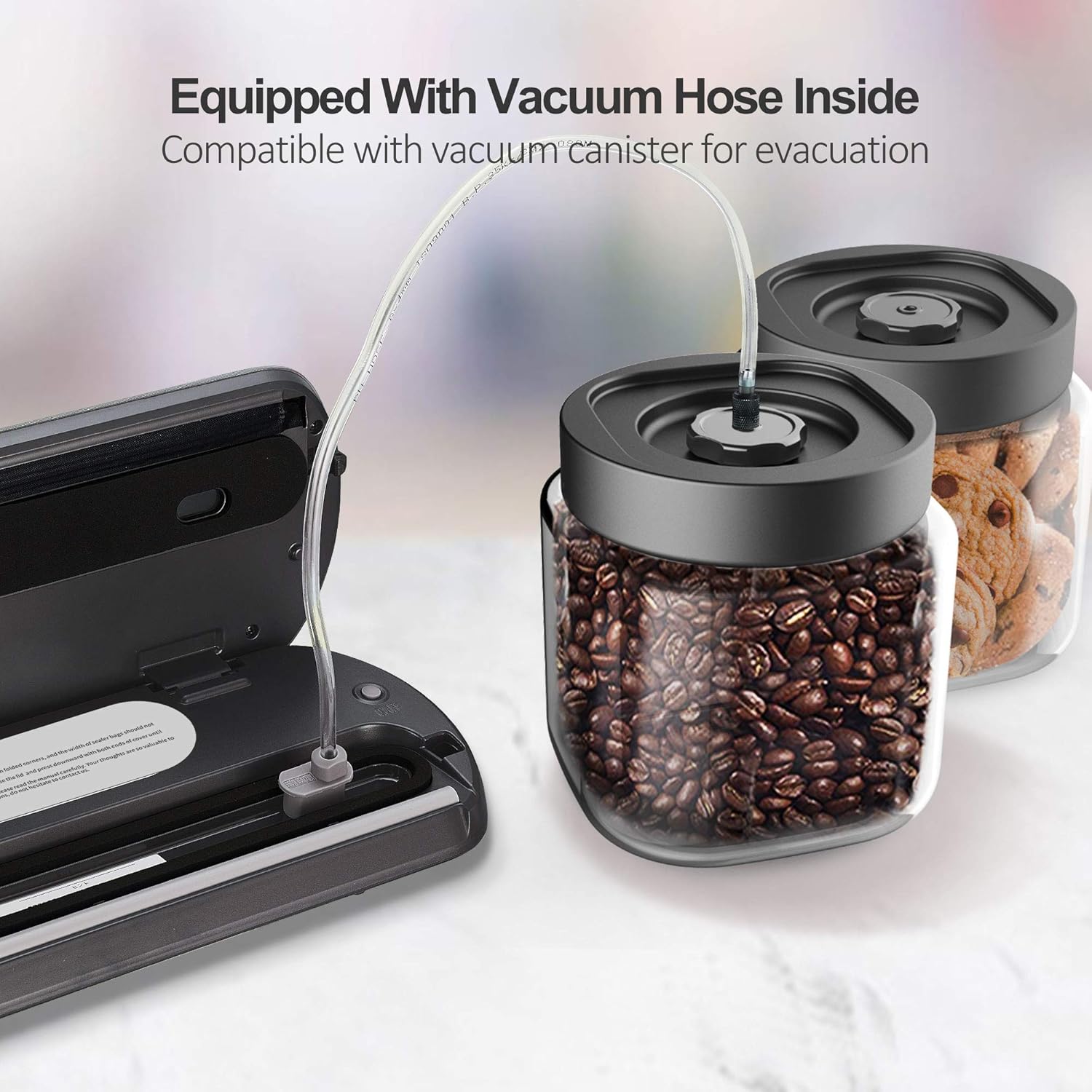 KitchenBoss G210 Vacuum Sealer with an attached hose vacuuming air from a canister of coffee beans.