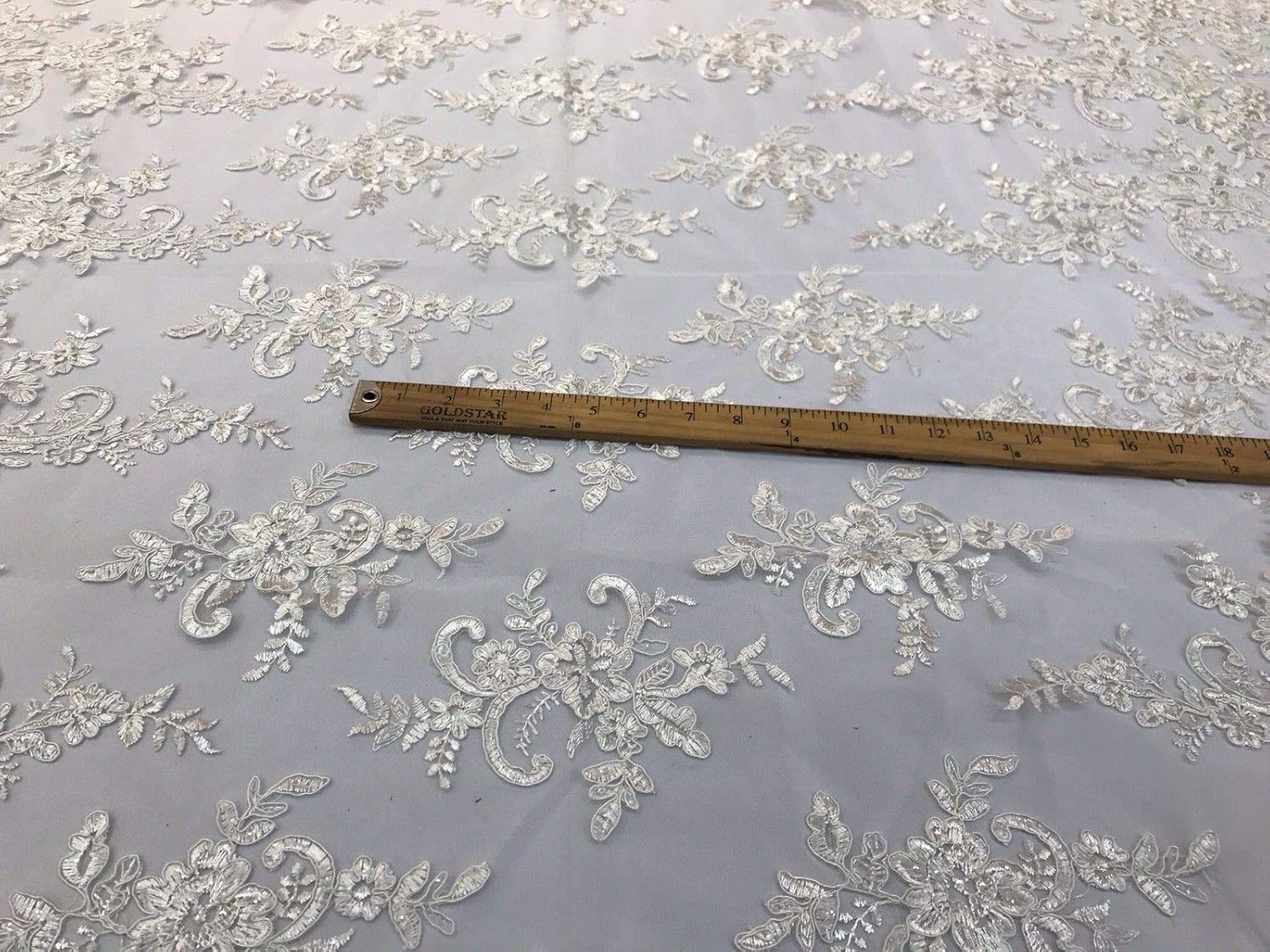 IVORY FLORAL DESIGN EMBROIDER WITH SEQUINS-CORDED LACE-SOLD BY THE YARD.